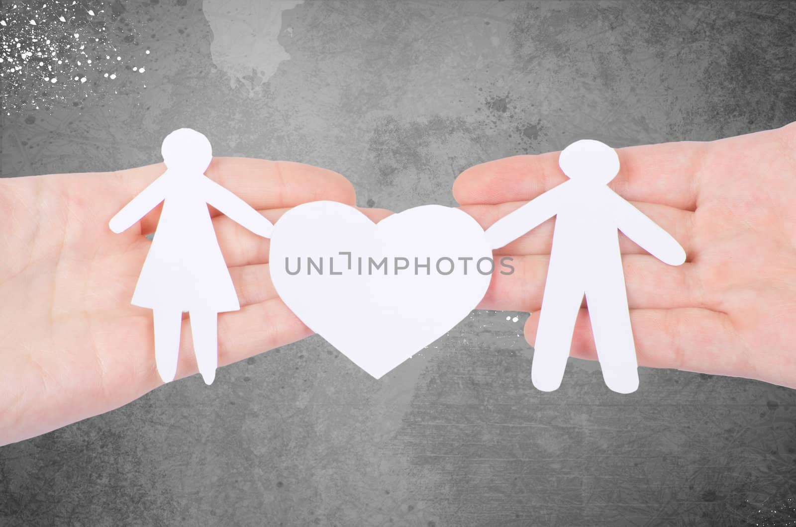 Paper family in hand with a big hearth isolated on white