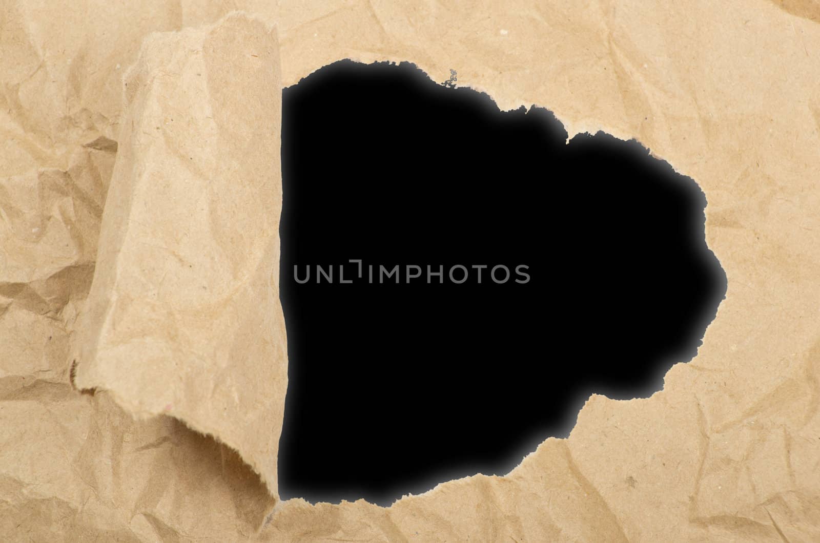ripped white paper against a black background