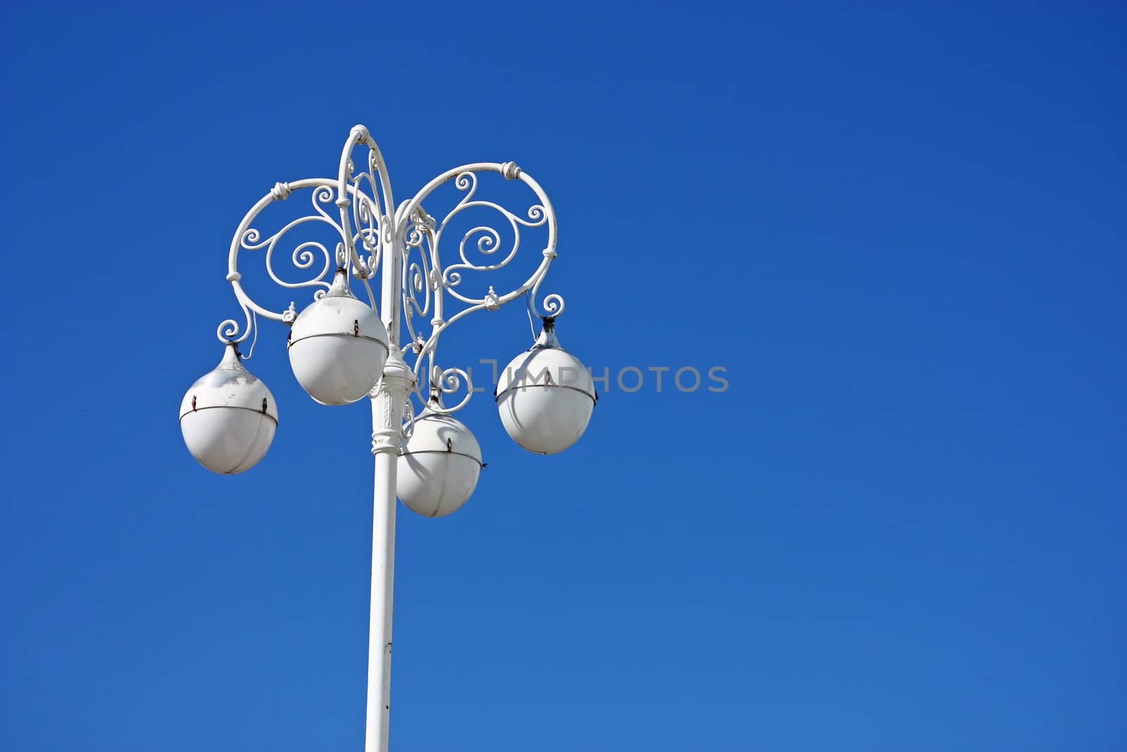 Street lamp in front of blue sky