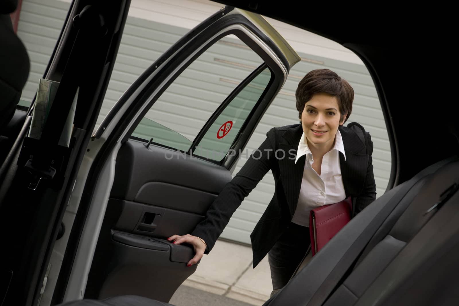 A business woman gets in the cab