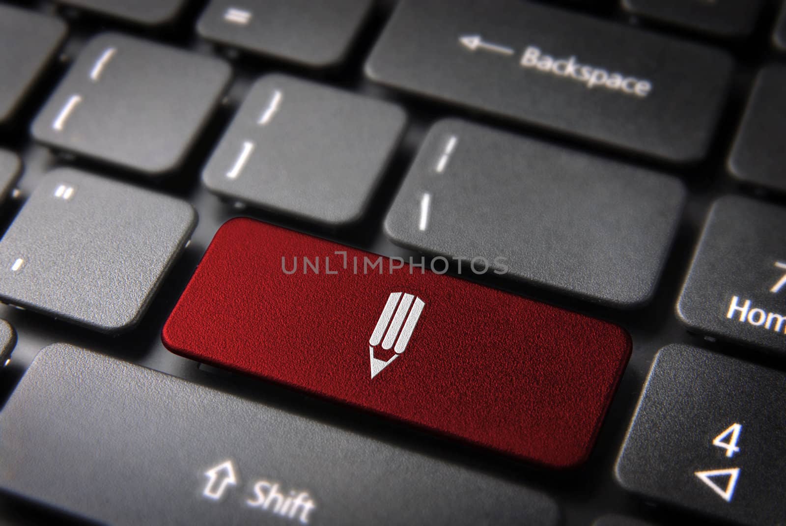 Red school design key with pencil on laptop keyboard. Included clipping path, so you can easily edit it.