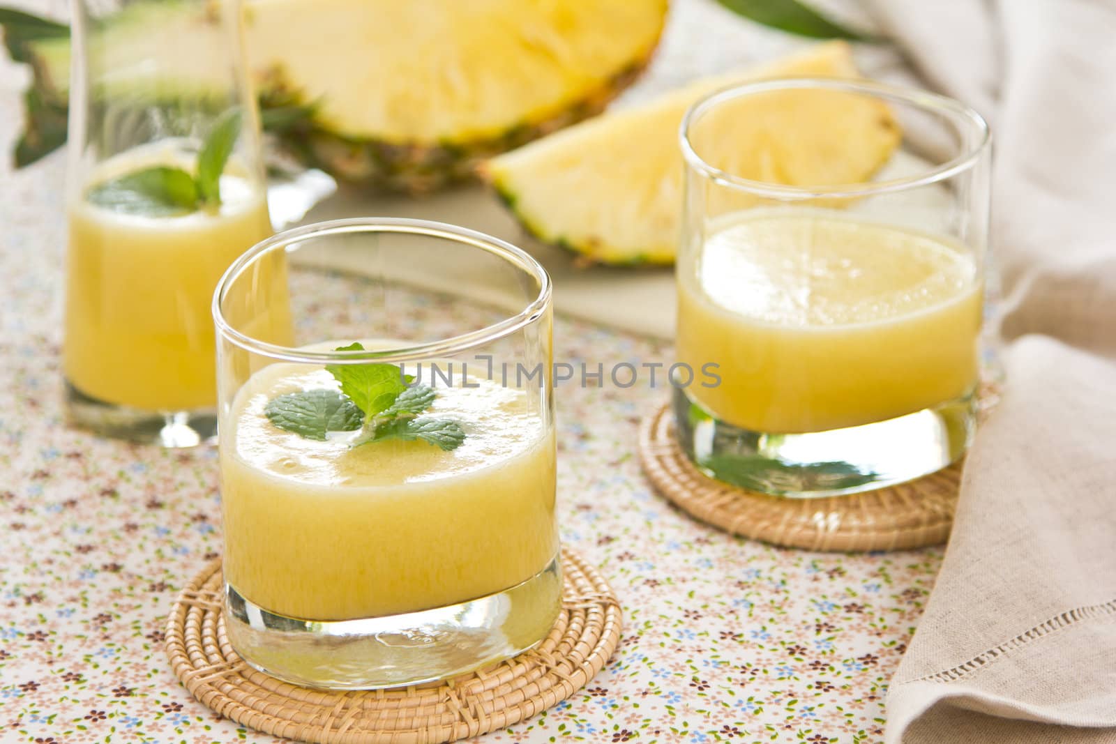 Pineapple juice [smoothie] with mint on top by fresh pineapple