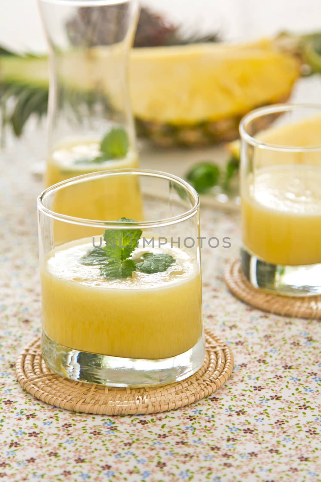 Pineapple juice [smoothie] with mint on top by fresh pineapple