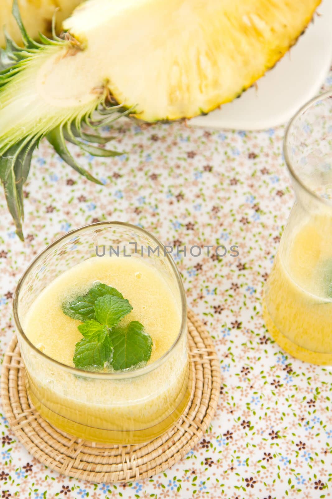 Pineapple juice [smoothie] with mint on top by fresh pineapple