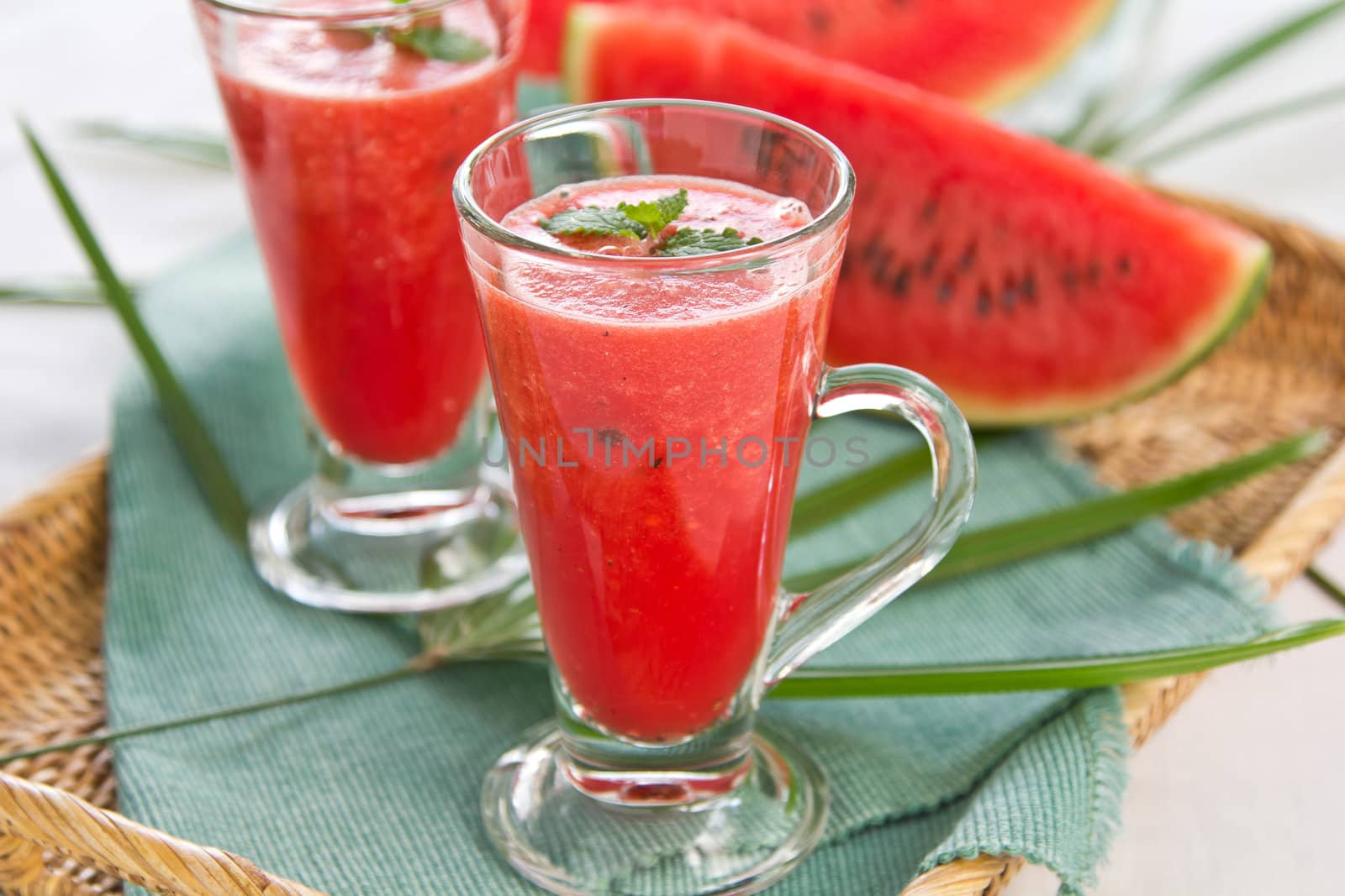 Watermelon smoothie  in glasses by some fresh watermelon