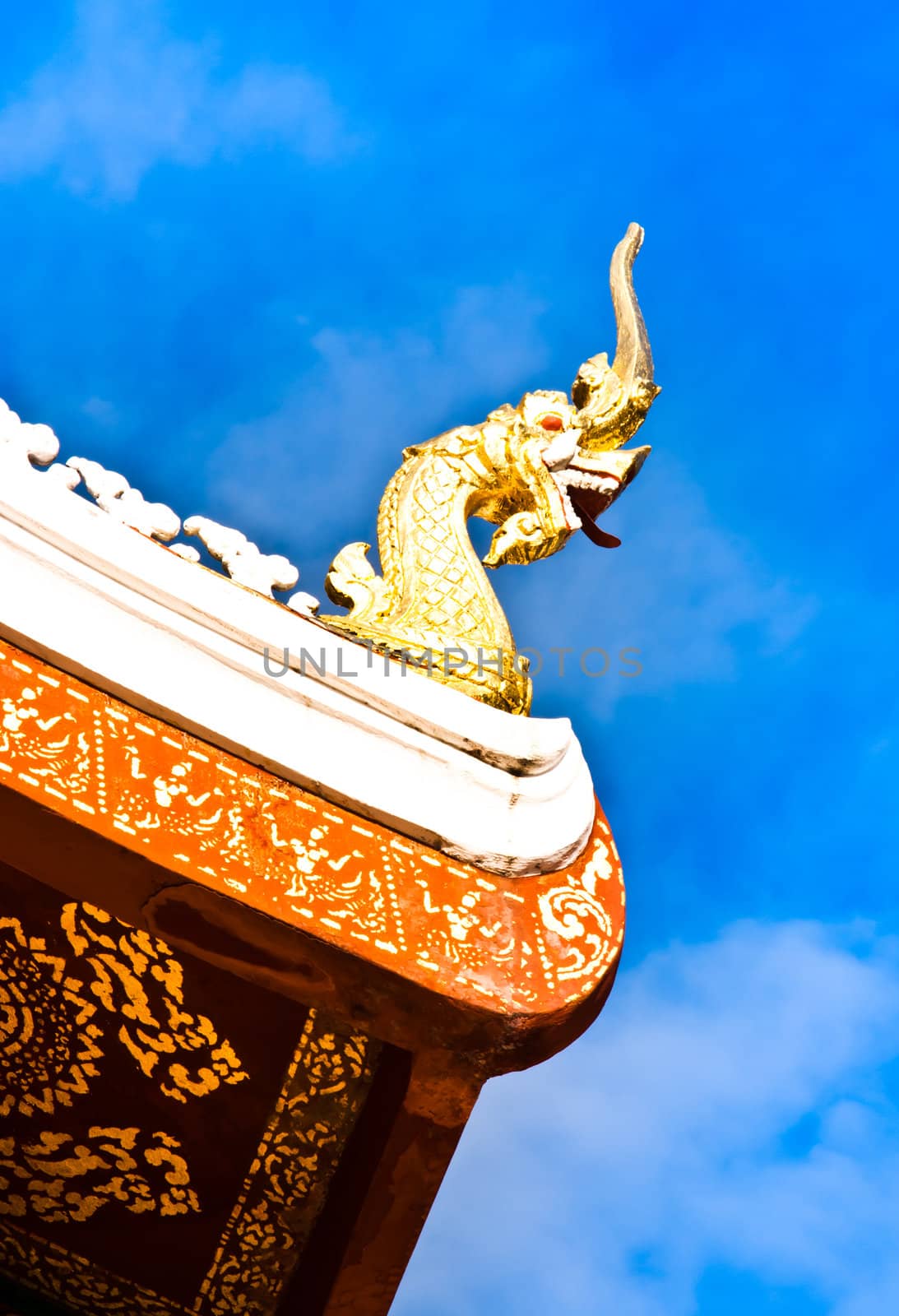 A golden serpent on the rooftop of a buddhist temple