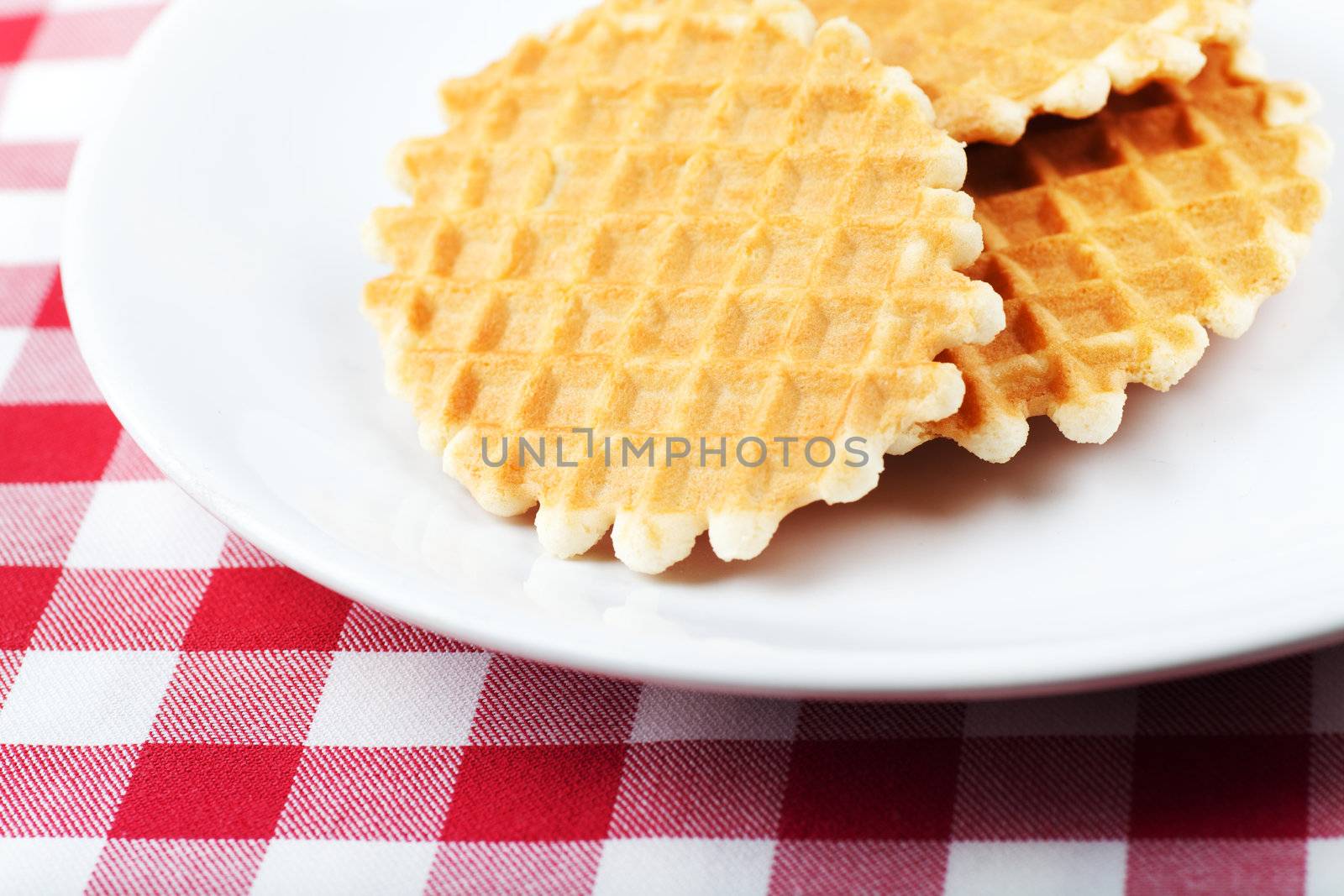 Golden round waffles on a white plate