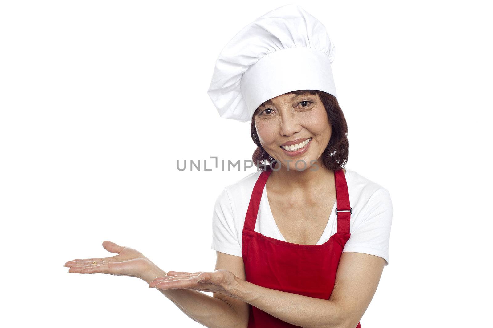 Smiling asian chef gesturing guests to take their seats. All on white background
