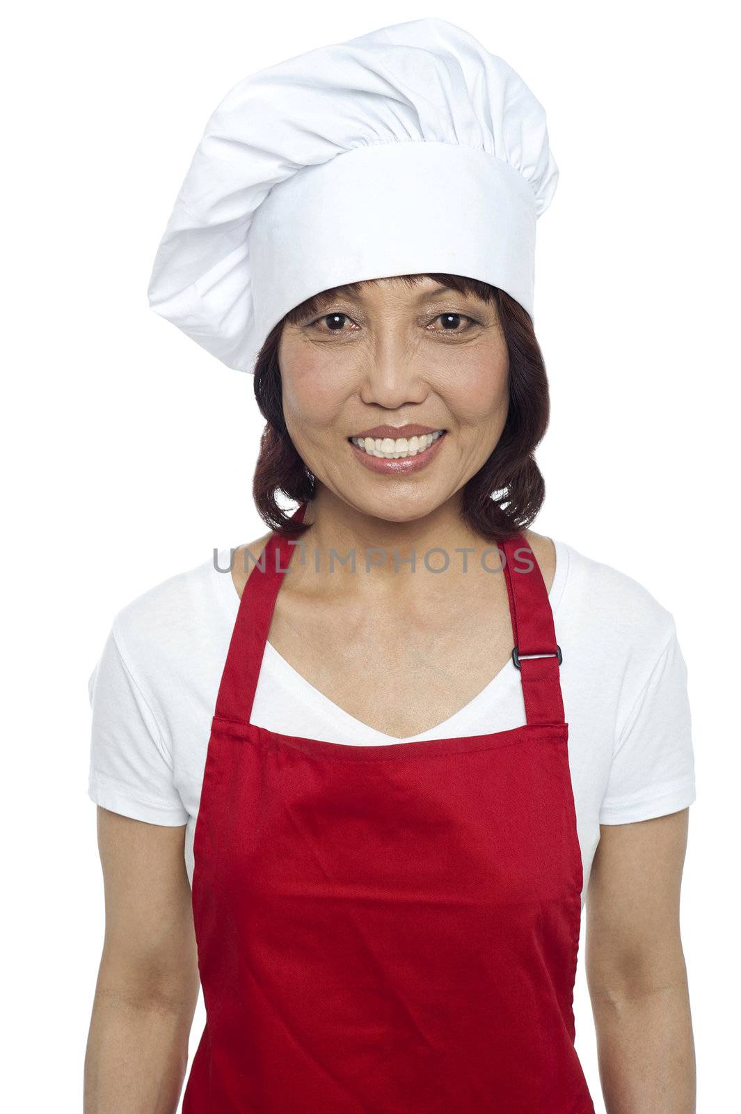 Young smiling female chef wearing red apron and toque