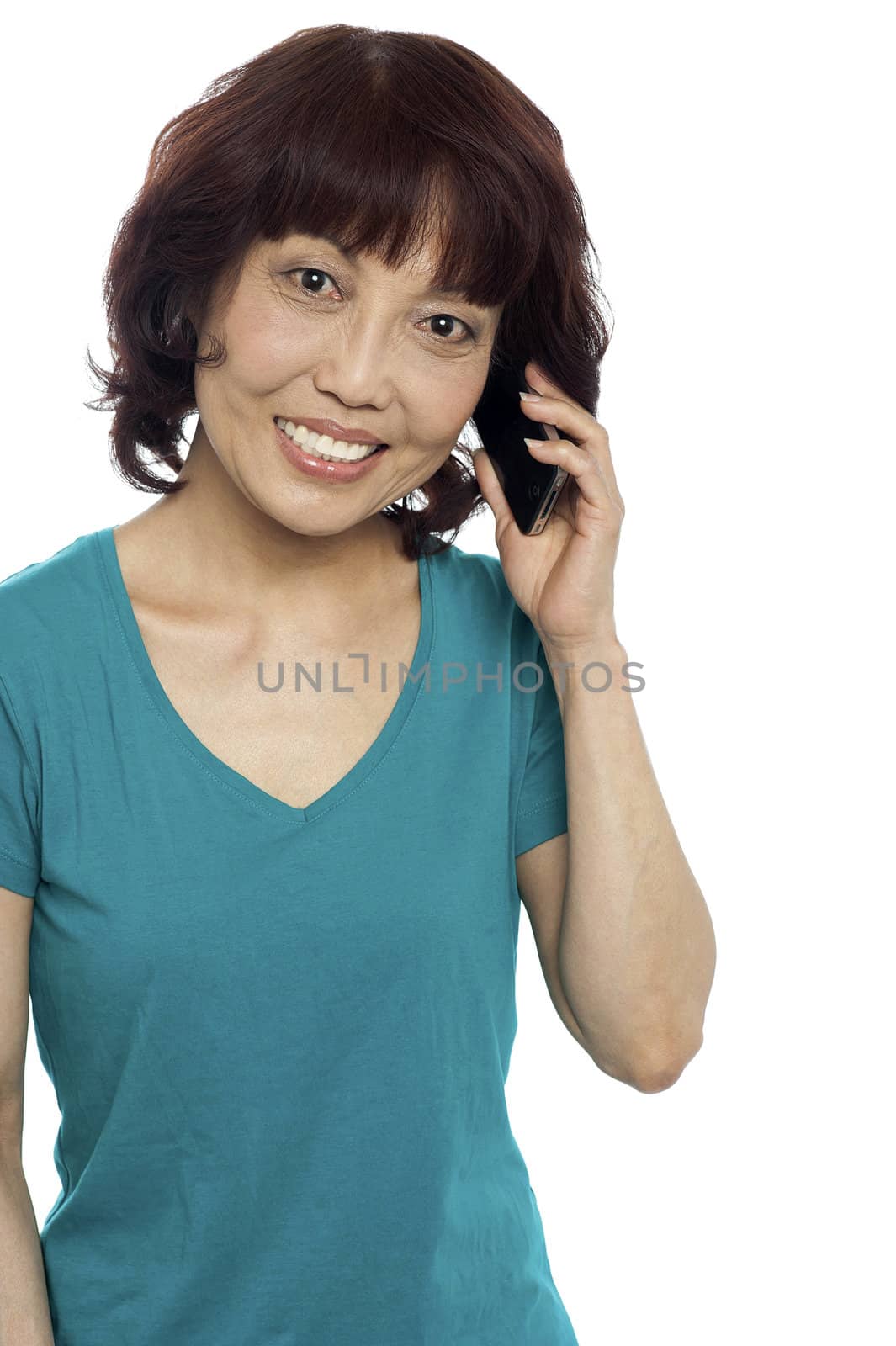 Pretty female communicating through cellphone, looking at you