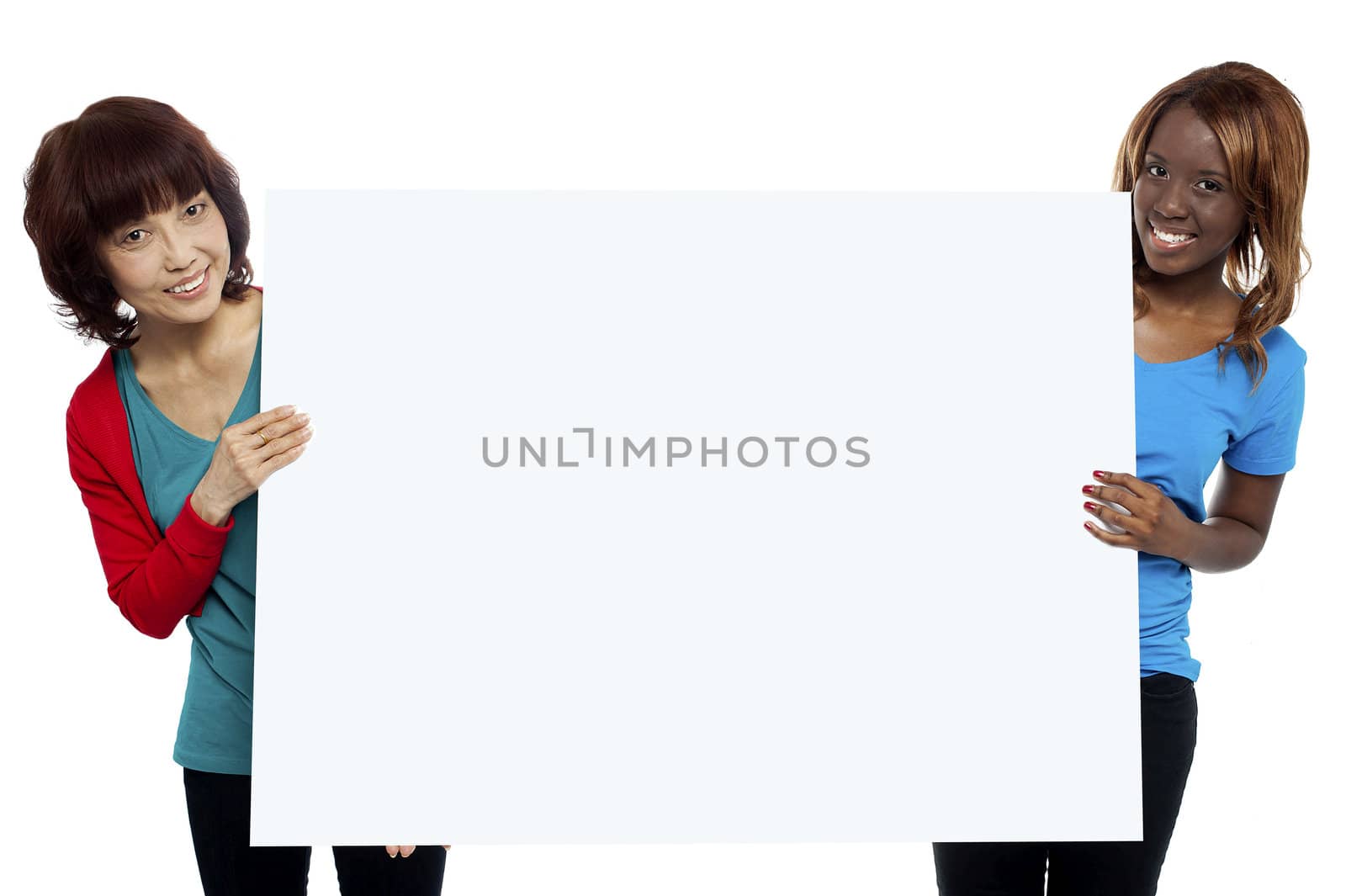 Two ethnic female models presenting whiteboard isolated against white background