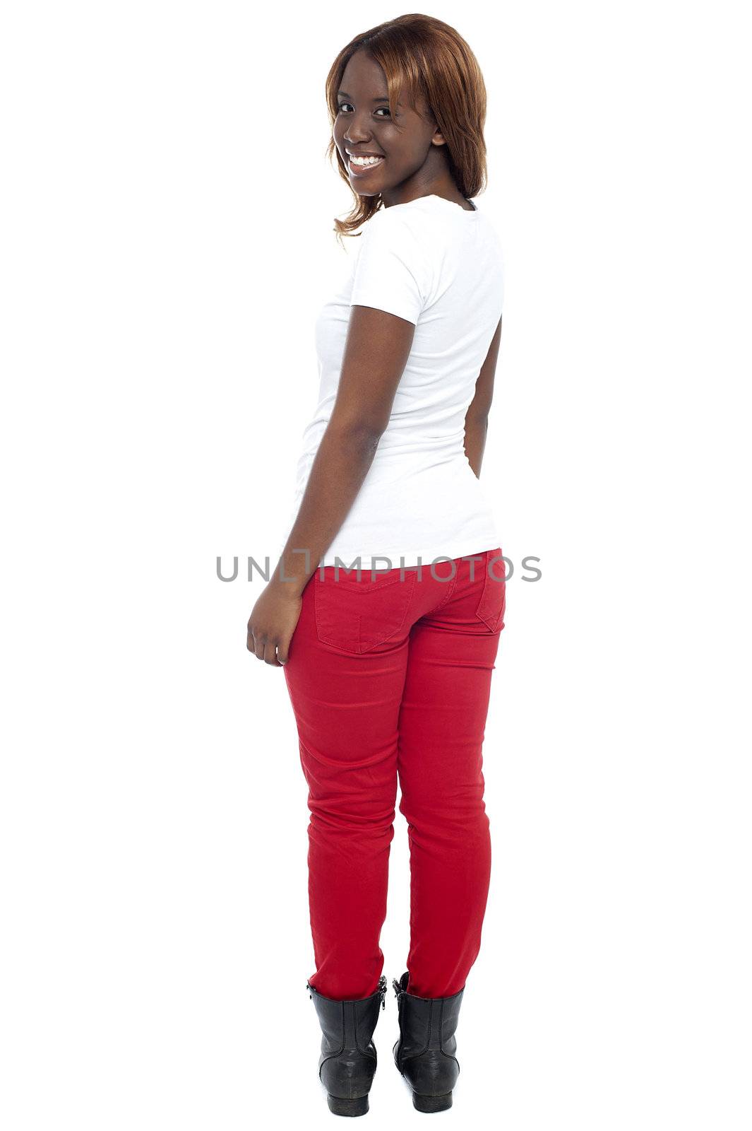 Smiling african lady in boots turning back, full length shot over white background