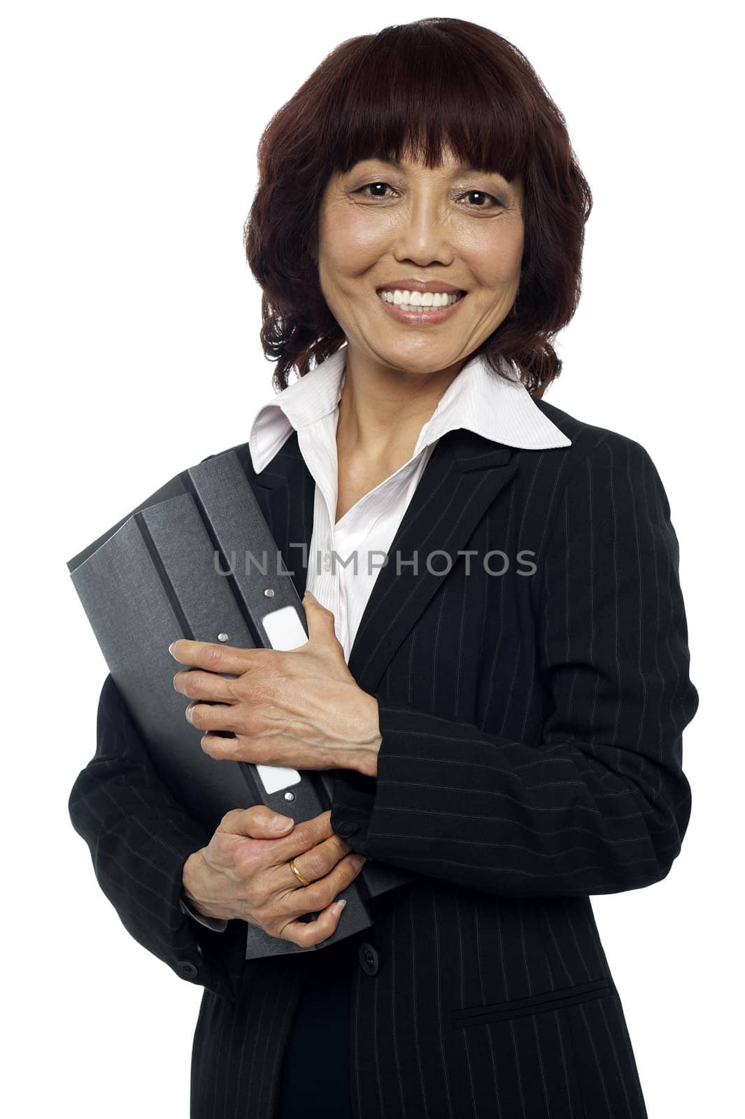 Smiling female executive holding binder and looking at you