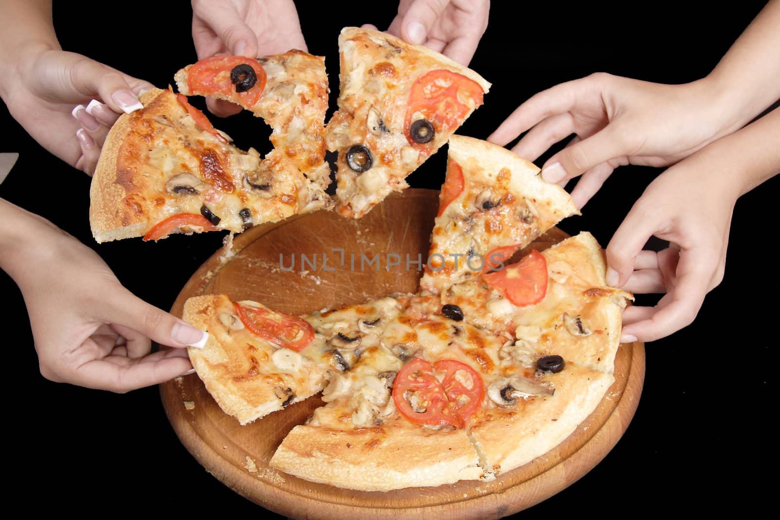 A group of people taking slices of pizza