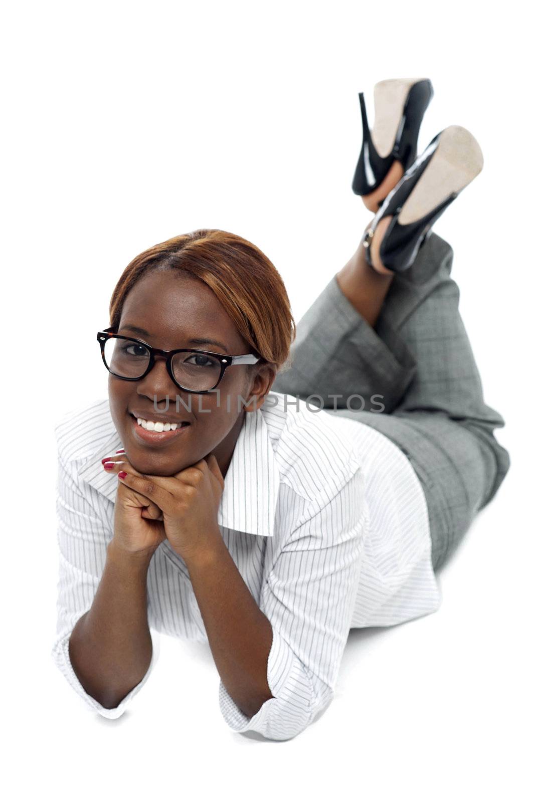 Relaxed african businesswoman lying on floor. Indoor studio shot