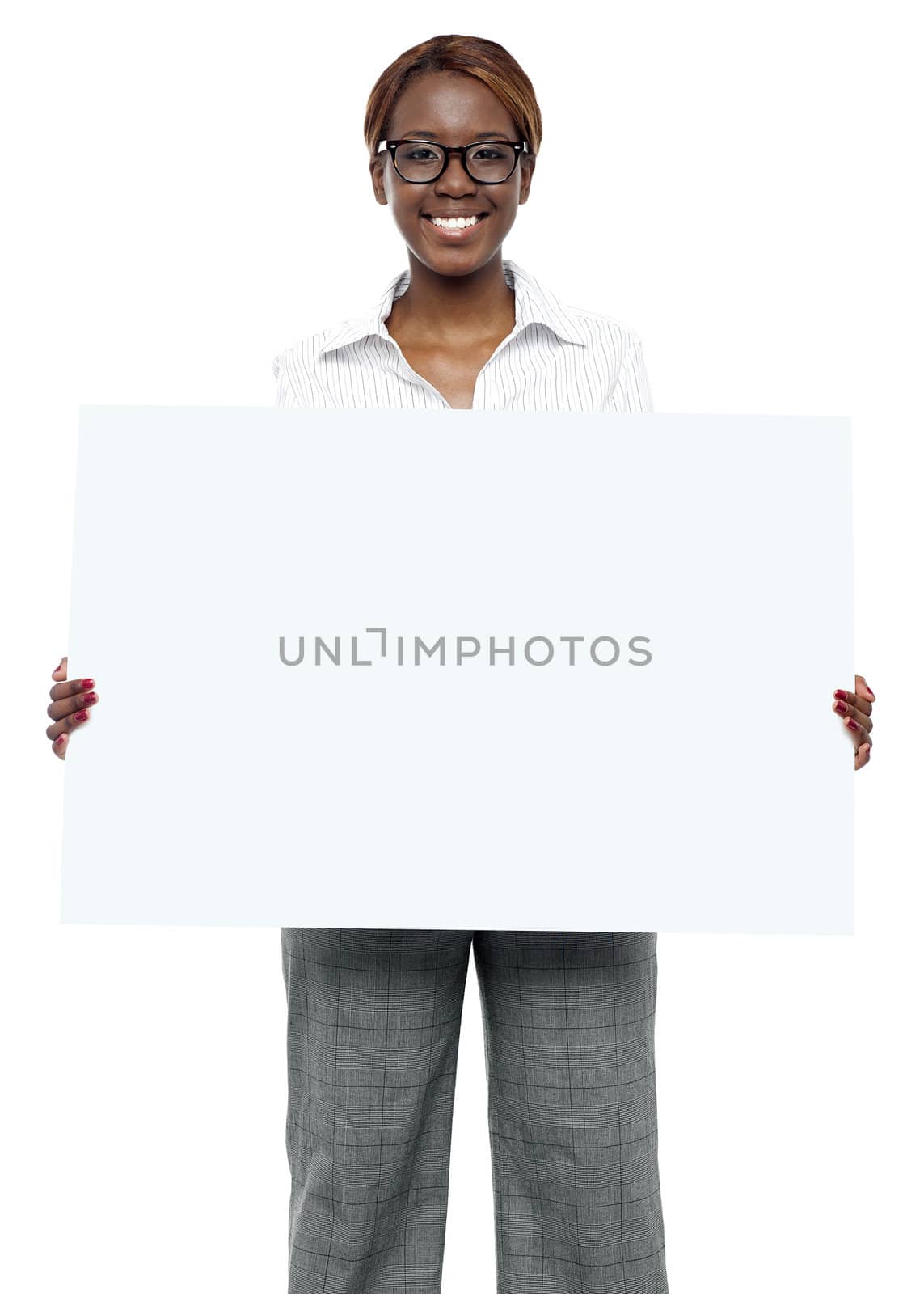 Female business executive holding blank billboard and showing it to camera