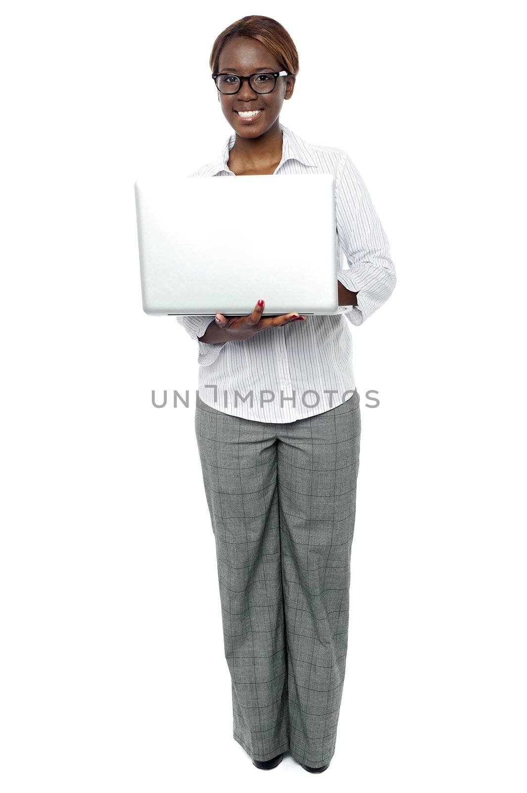 Full length portrait of female business secretary working on laptop