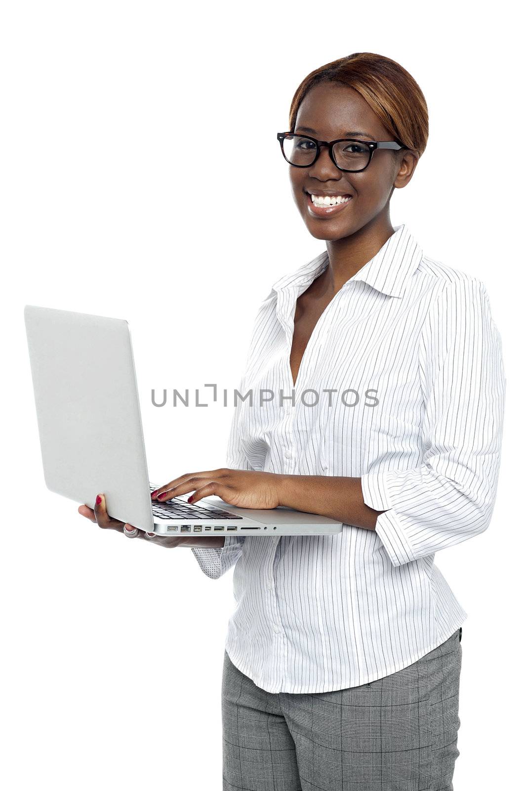 Female executive typing on laptop and working. Isolated over white background