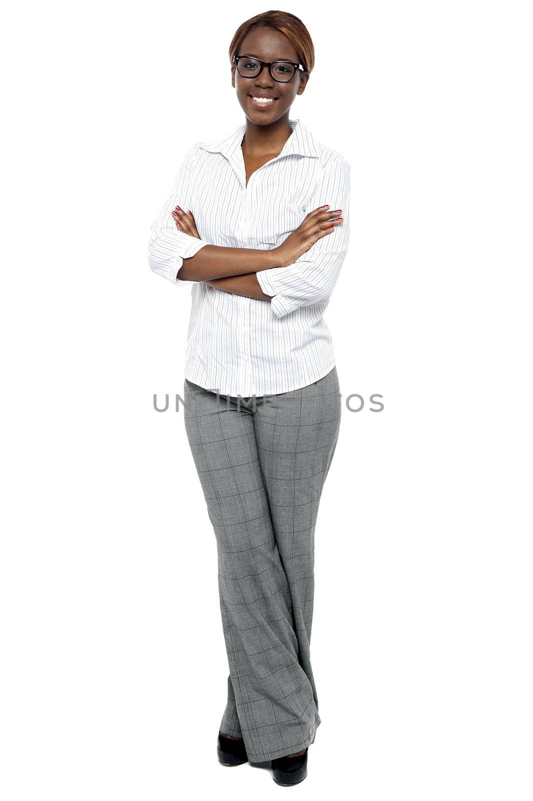 Full length shot of attractive female consultant. Arms folded and legs crossed