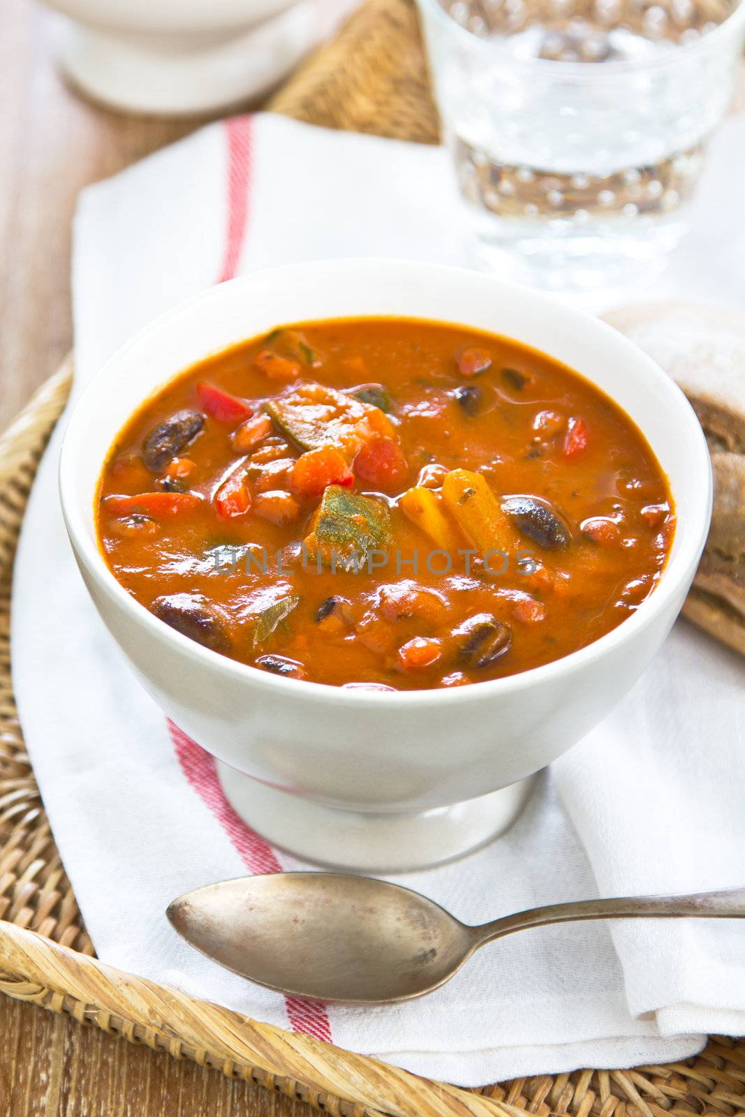 Minestrone soup [Zucchini,aubergine,bean,pepper and carrot in tomato soup ] by a loaf of bread