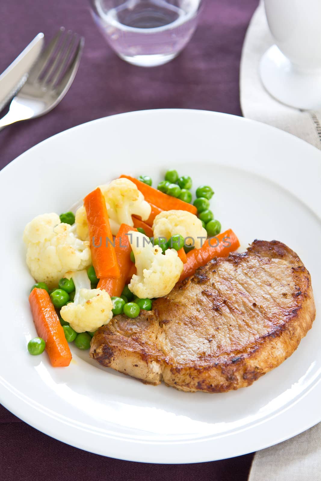 Pork steak with sautéed vegetable by vanillaechoes