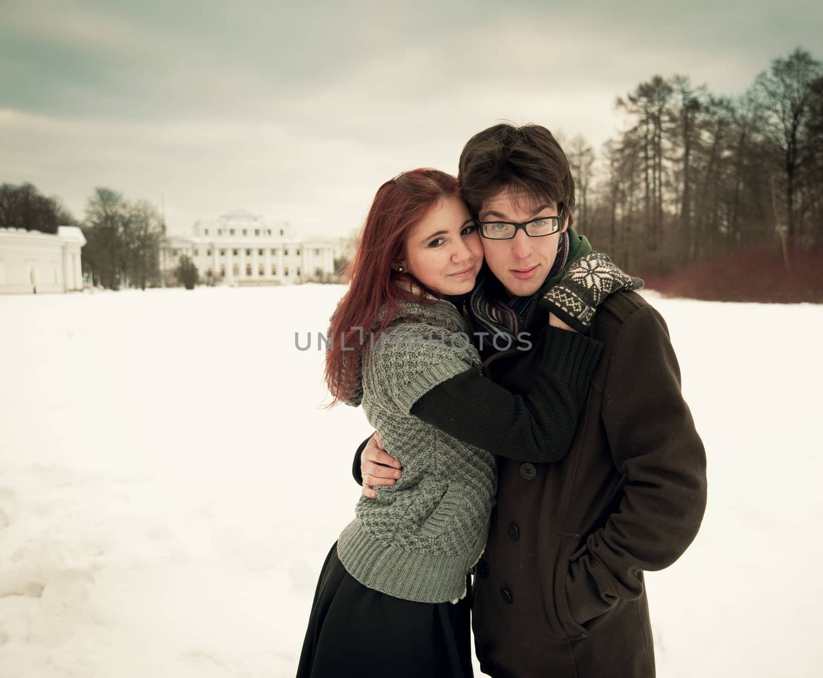 man and woman embracing in winter