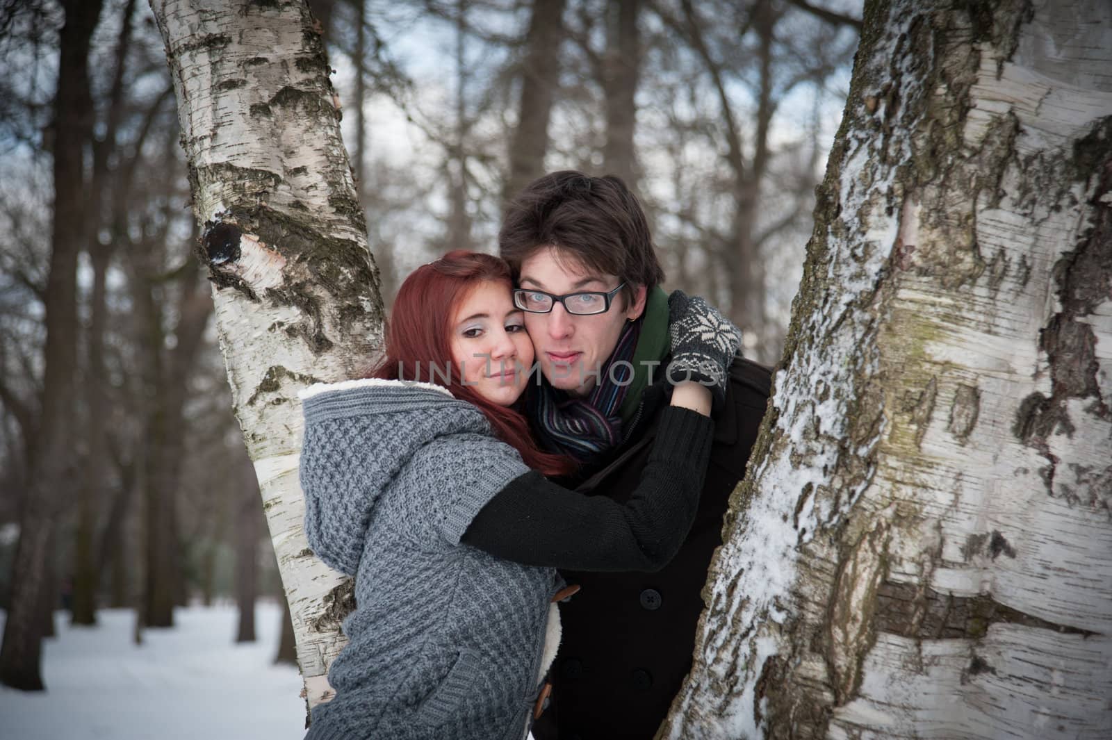 man and woman embracing in winter