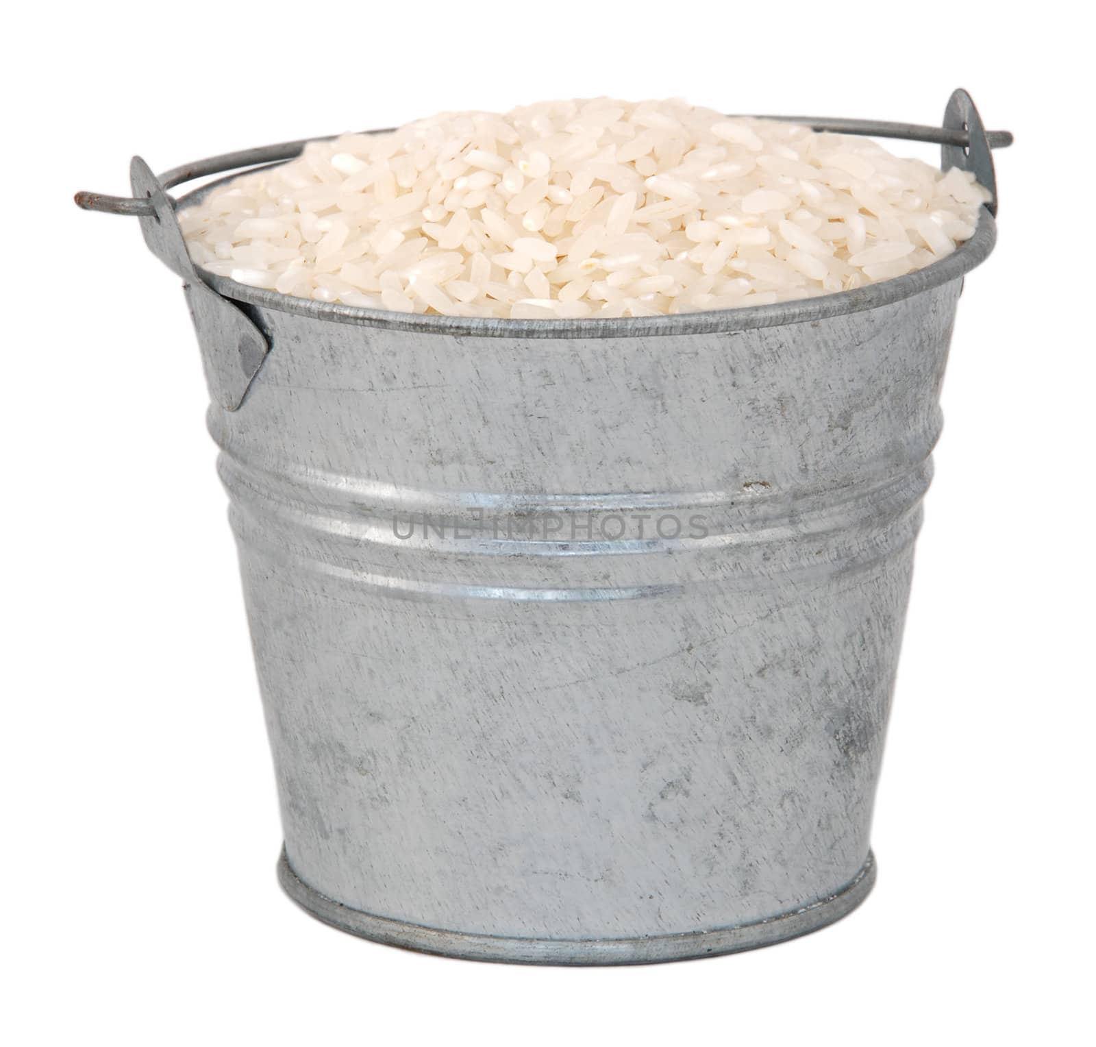 White long grain rice in a miniature metal bucket, isolated on a white background