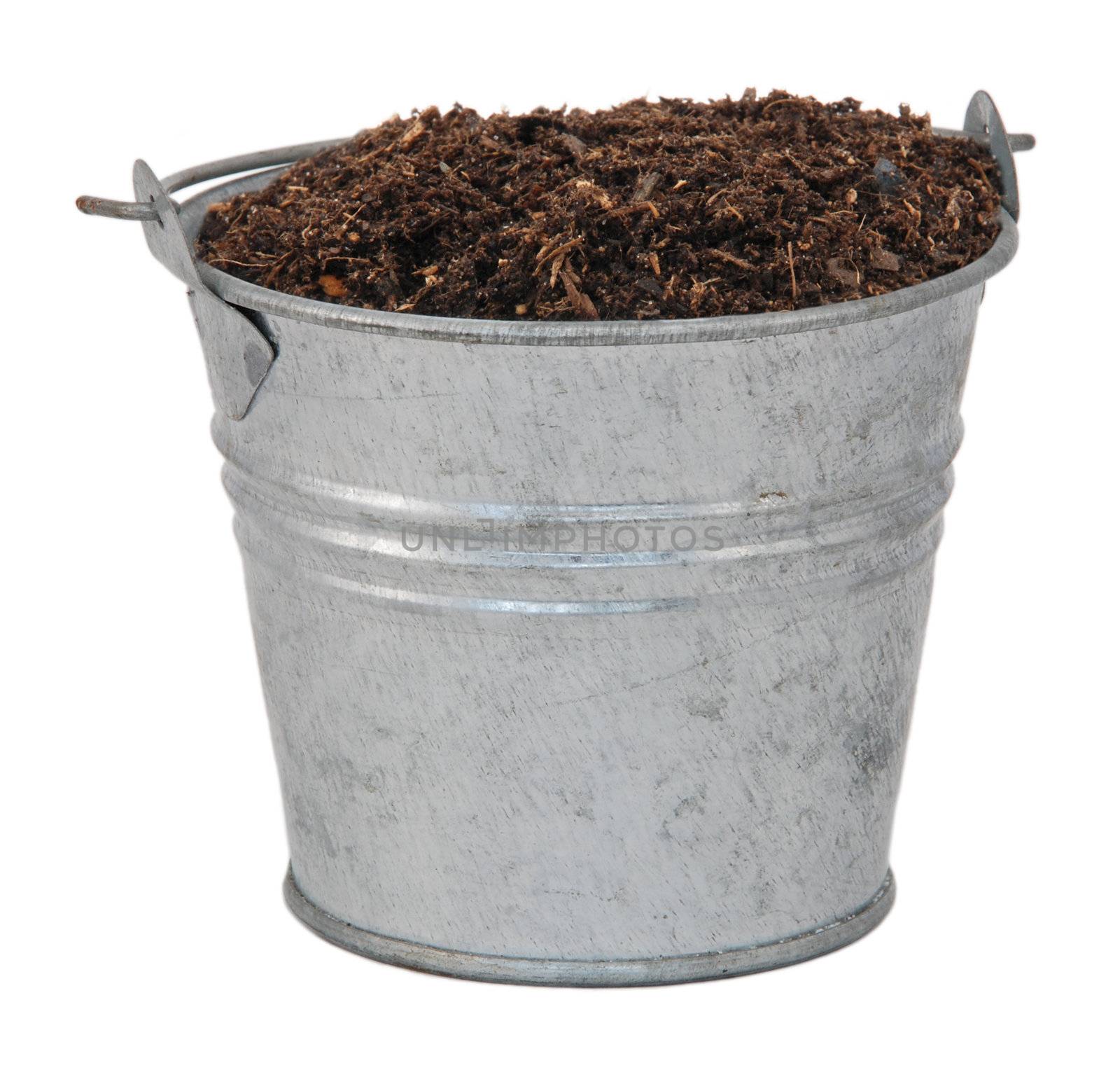 Compost / soil / dirt in a miniature metal bucket, isolated on a white background