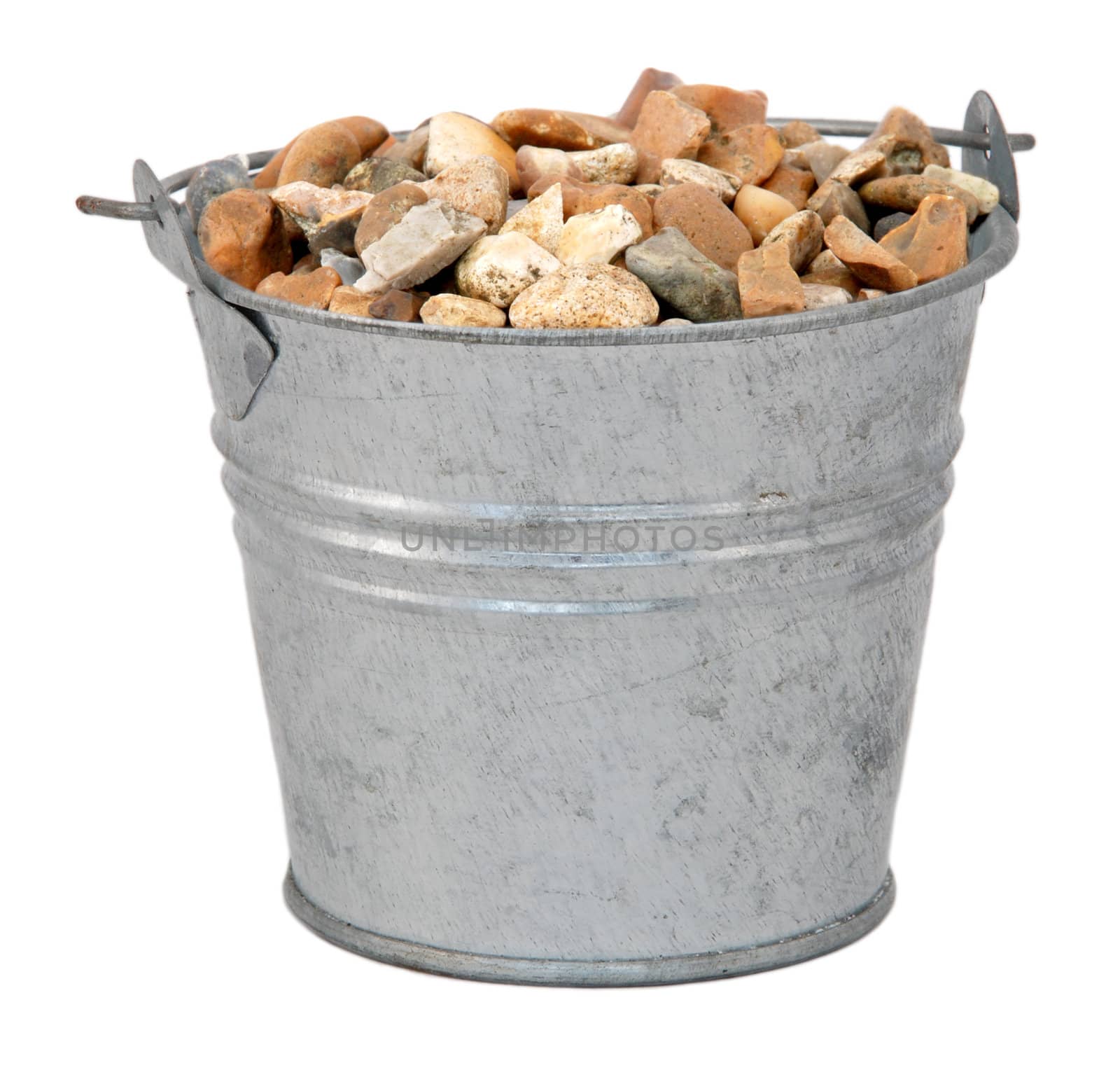 Gravel / small stones in a miniature metal bucket, isolated on a white background