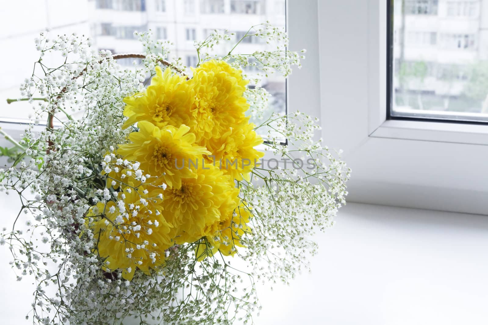 Fresh spring flowers in a vase on a window sill