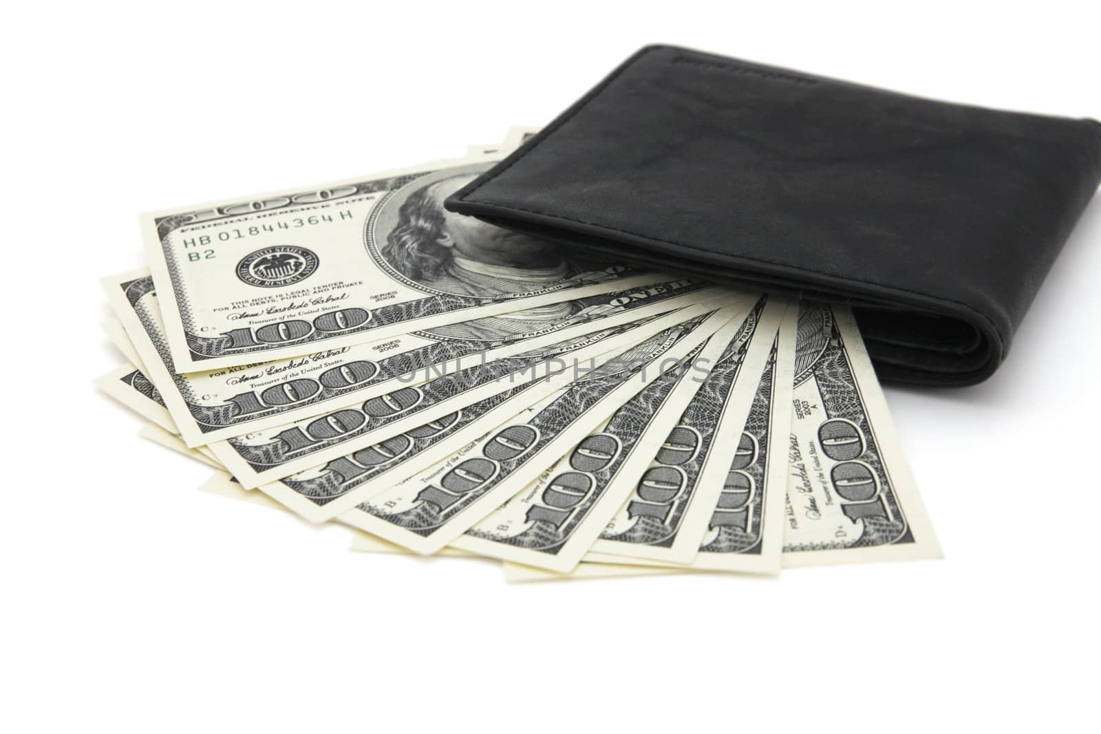 Black leather purse and dollars on a white background