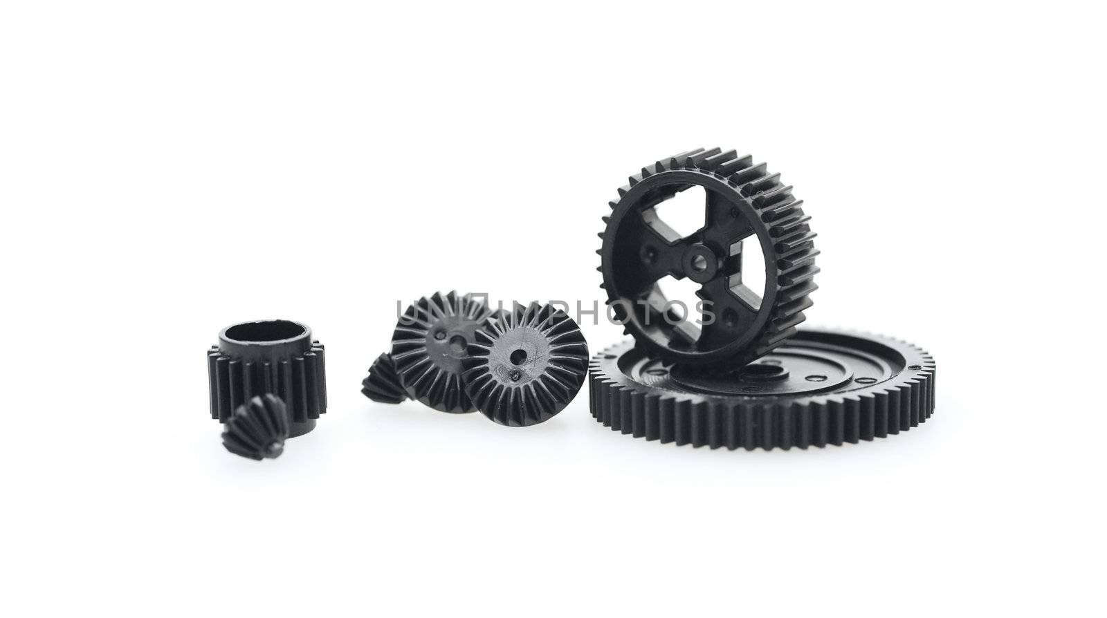 Black metal gear wheels of the different size on a white background
