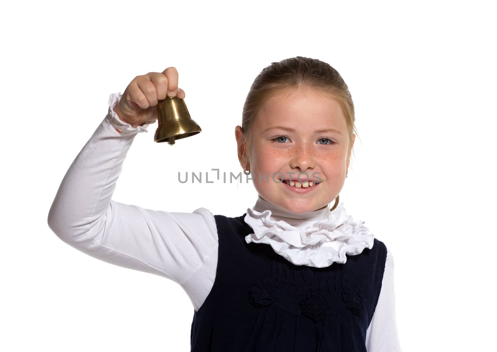 Young school girl ringing a golden bell on white background