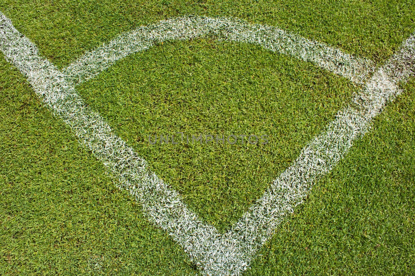 Corner of a football (soccer) field is made from synthetic lawn
