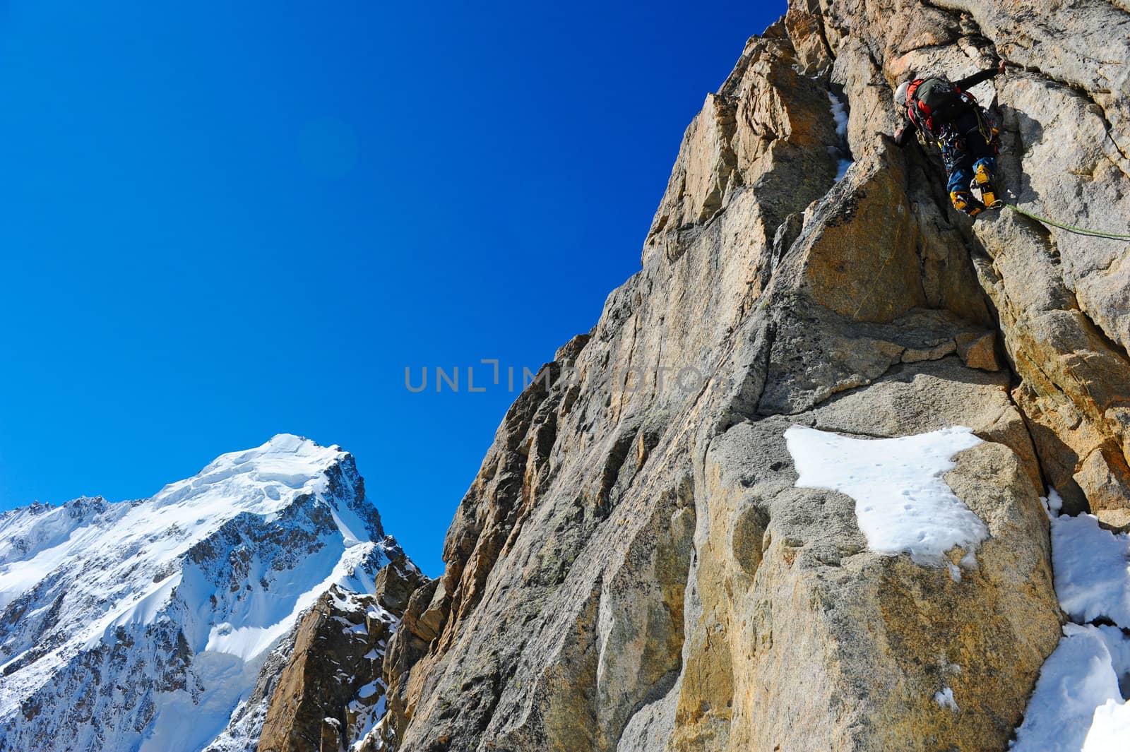 Mountaineer sport. A climber reaching the summit of the mountain