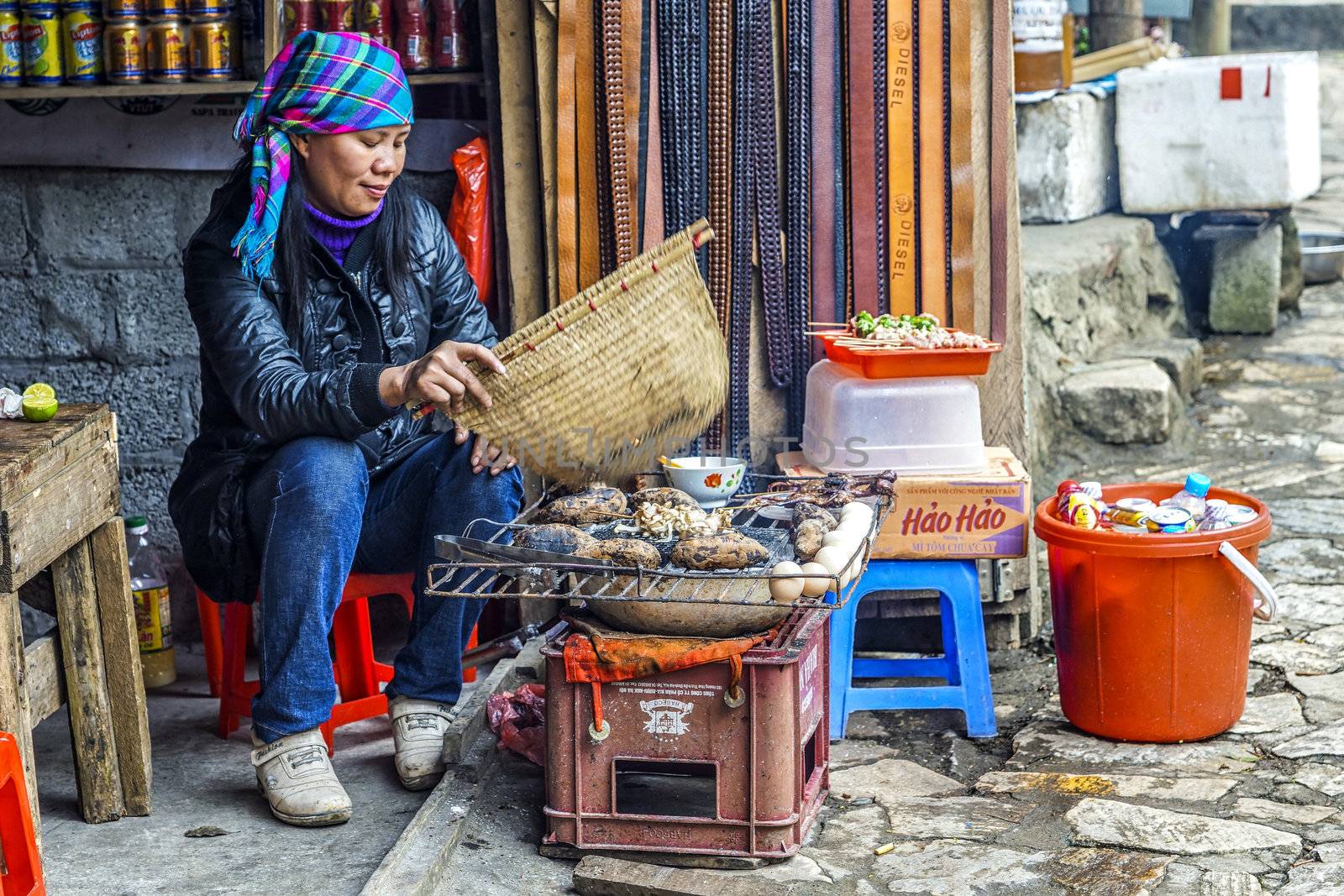 Vietnam Cat Cat - March 2012: Street vendor barbecues sweet pota by Claudine