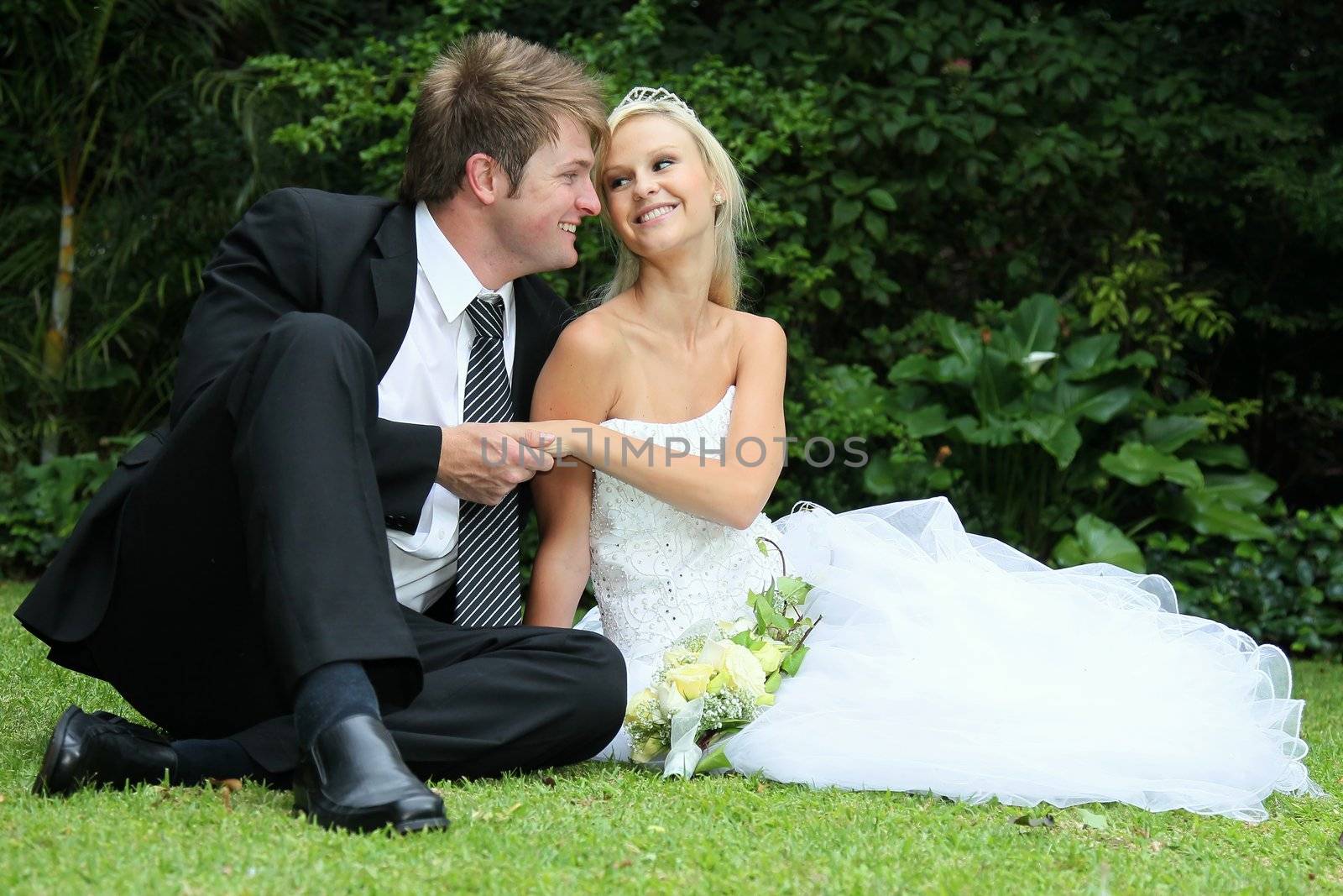 Lovely young couple sitting together on their wedding day