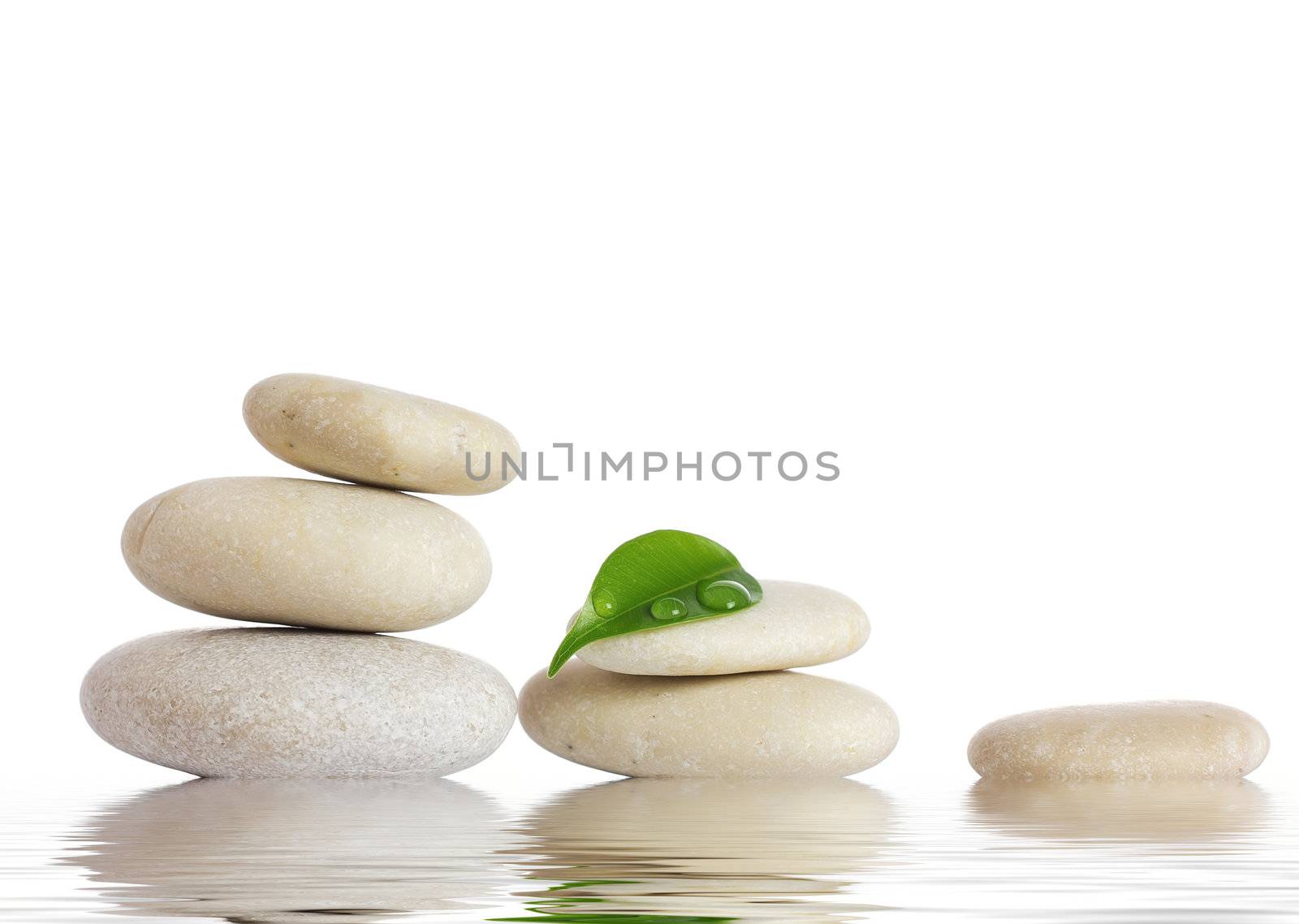 Spa stones and green leaf, isolated on white background.