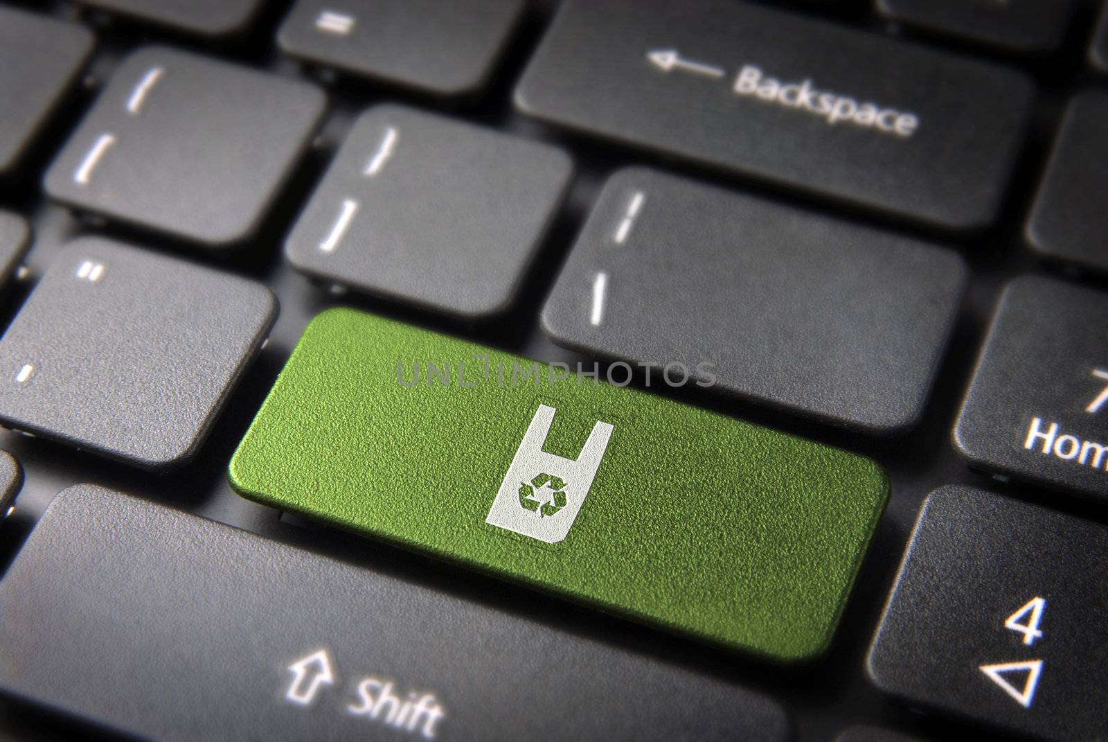 Go green key with recycle plastic bag icon on laptop keyboard. Included clipping path, so you can easily edit it.