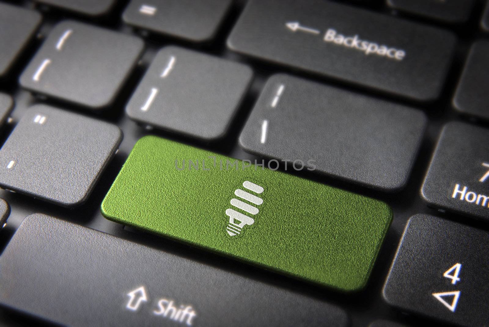 Green energy key with eco bulb light icon on laptop keyboard. Included clipping path, so you can easily edit it.