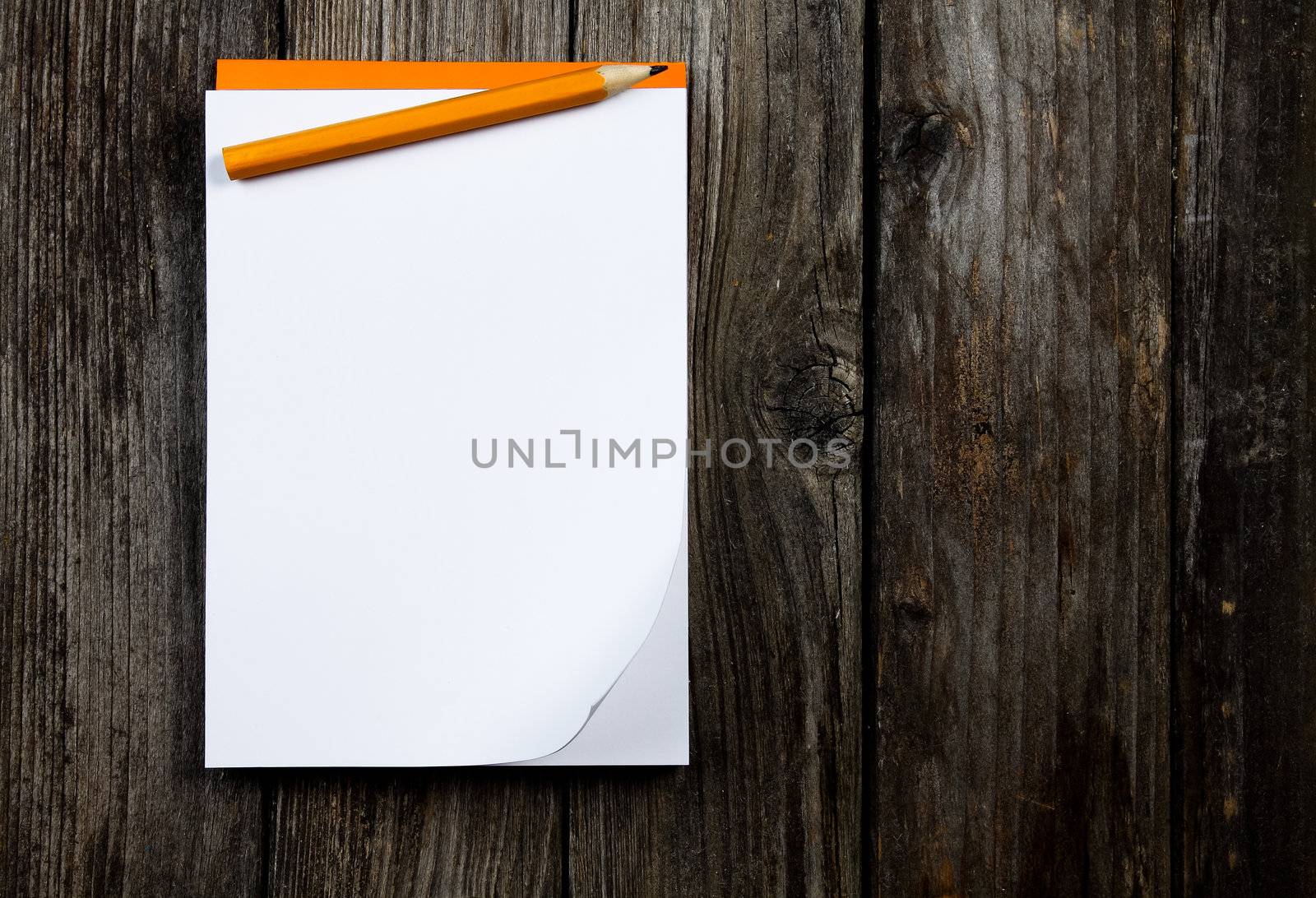 notepad and pencil on a wooden planks