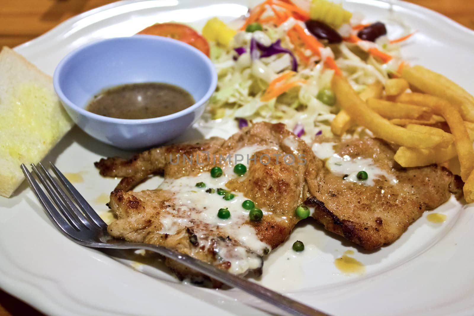 rk steak with salad, French Fries.