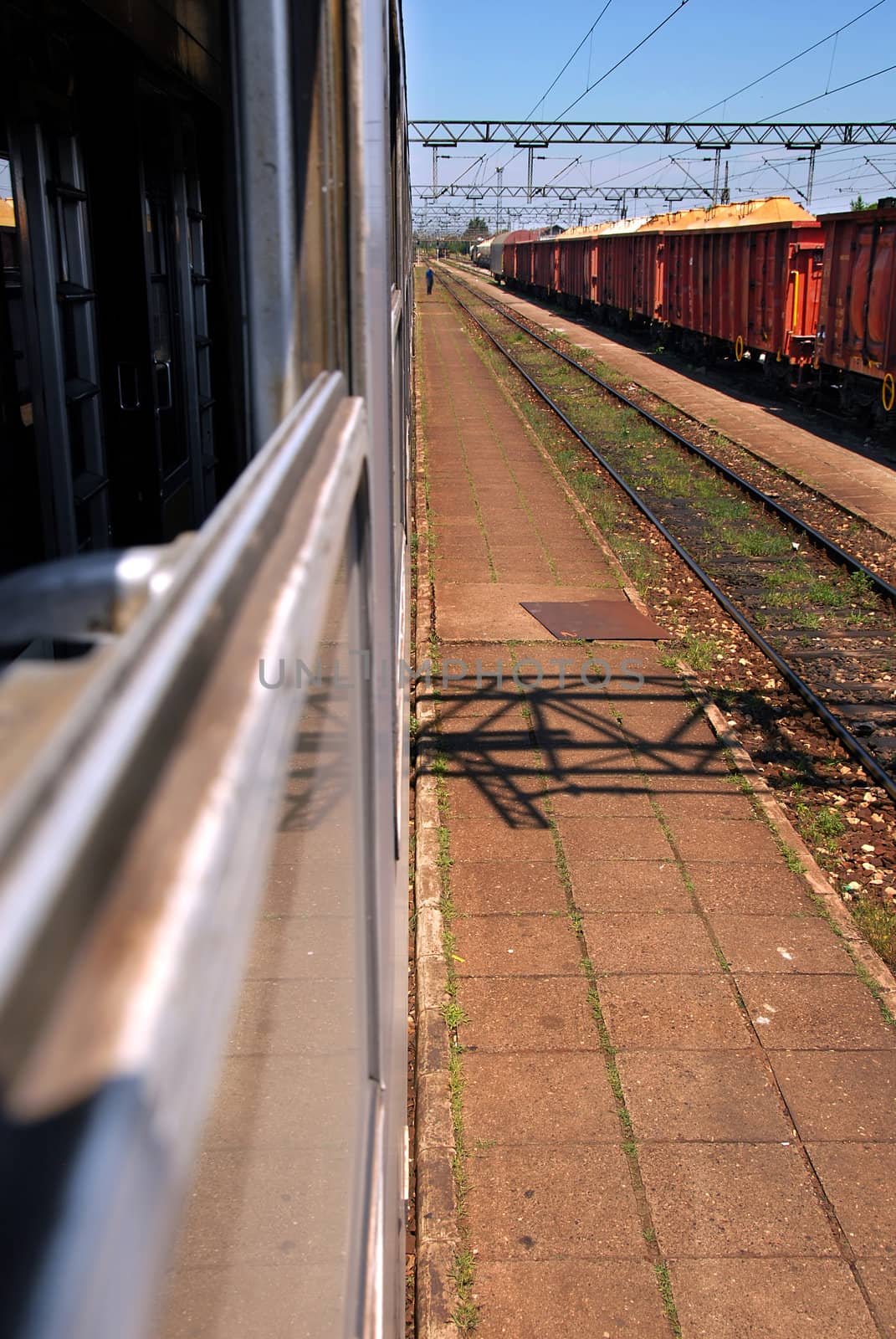 railway with passenger and cargo trains through the window