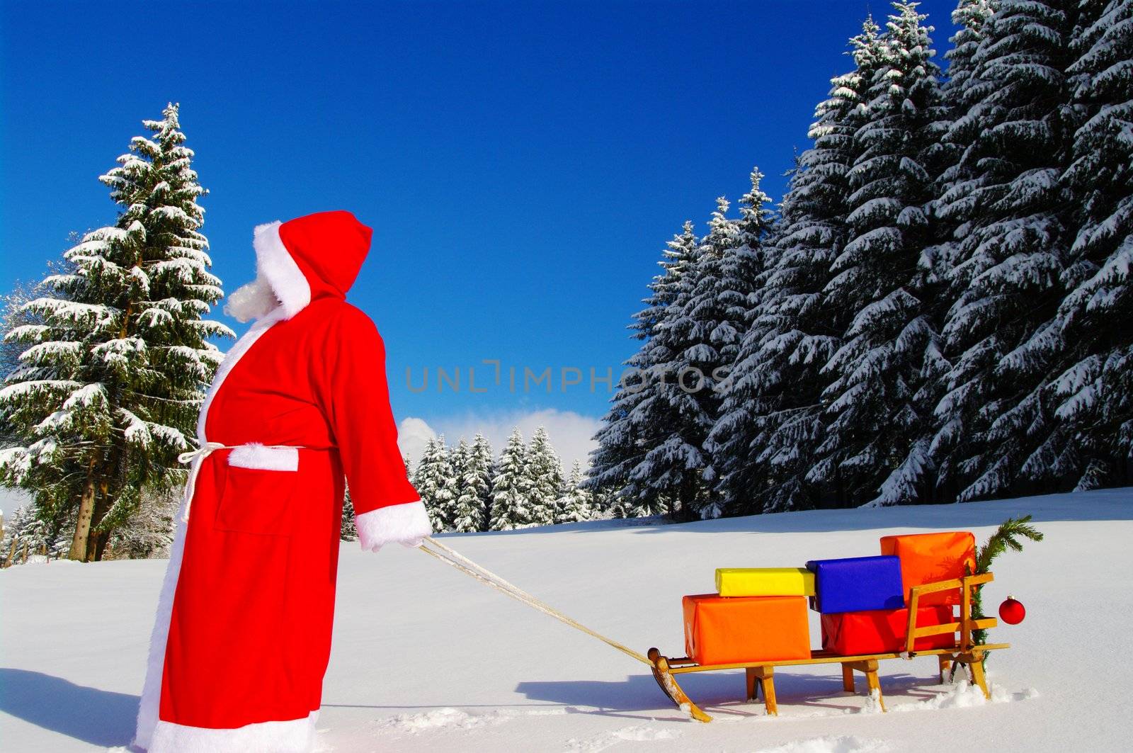 Santa Claus, Father Christmas with colorful presents on a sledge