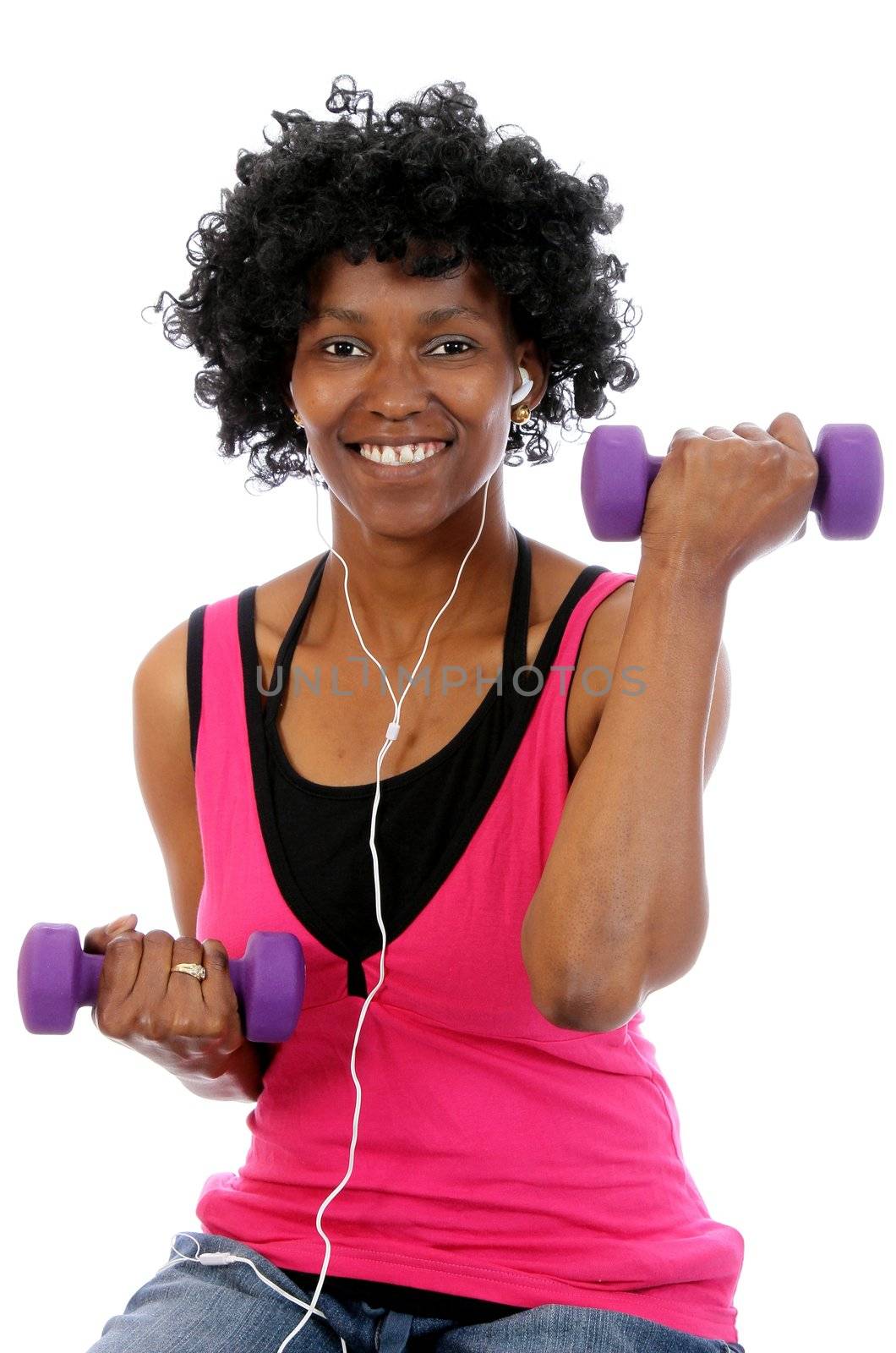 Happy African woman working out with gym weights and listening to music on earphones
