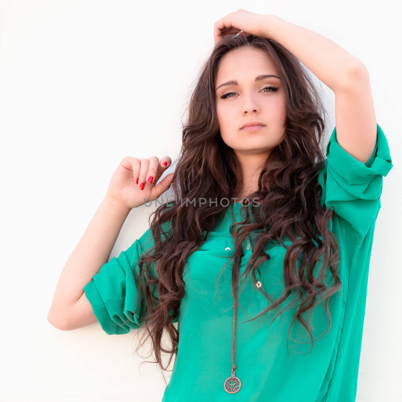 Young elegant woman on a white wall backround by Emevil