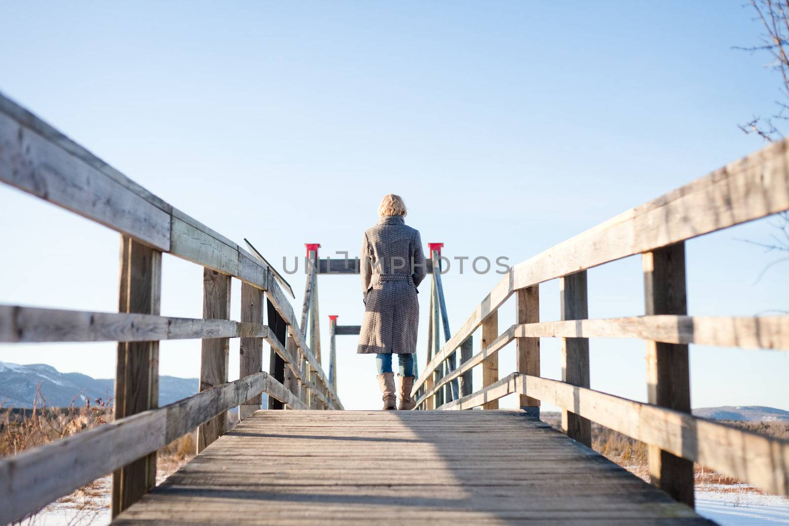 Girl walking on the bridge in the field