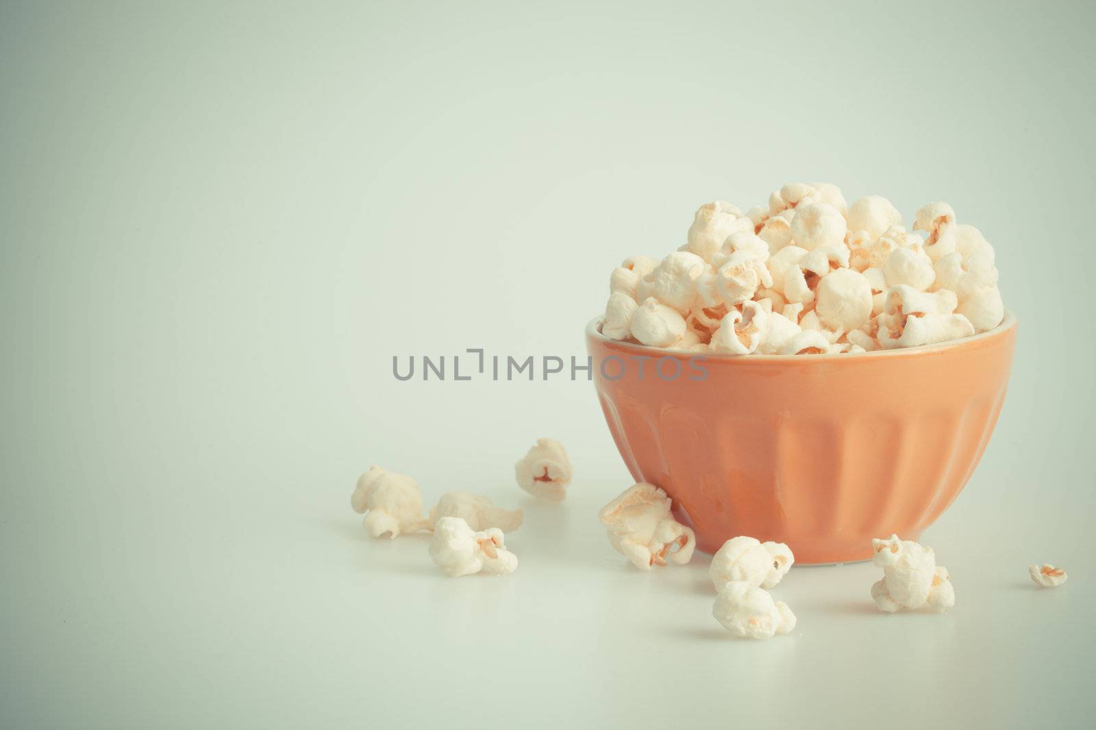 Orang popcorn bowl on a white background