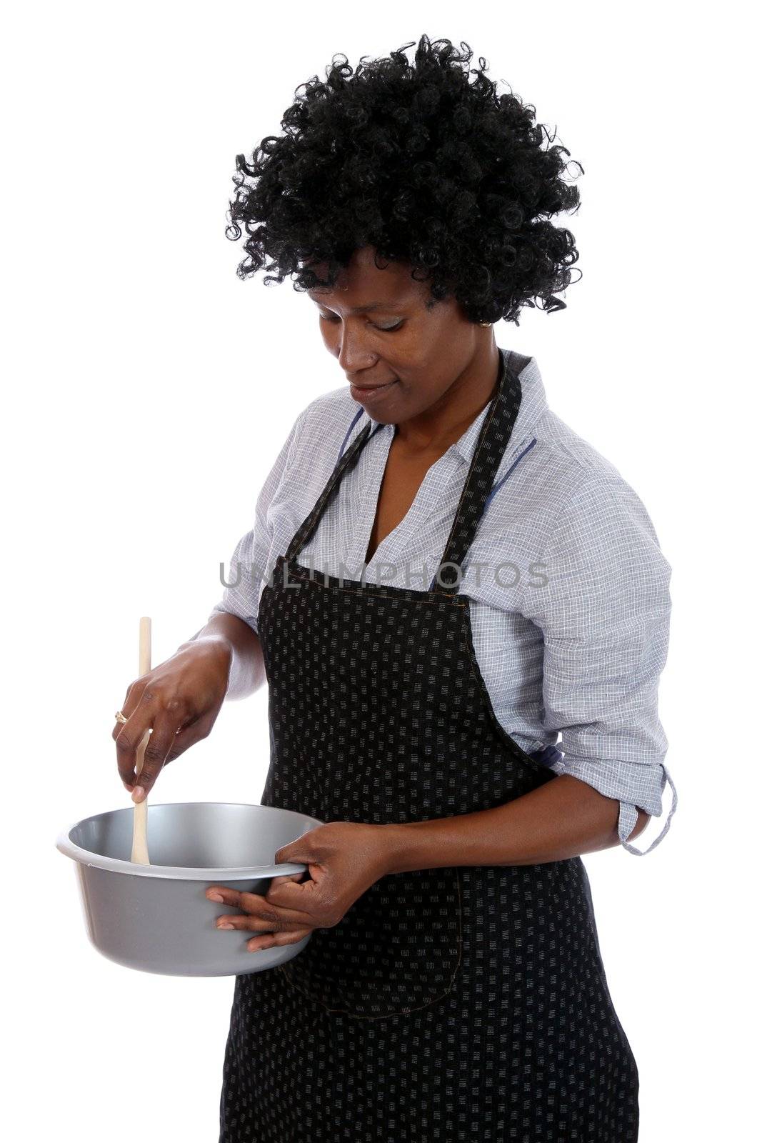 African woman with curly black hair stirring a cooking mixture in a pot